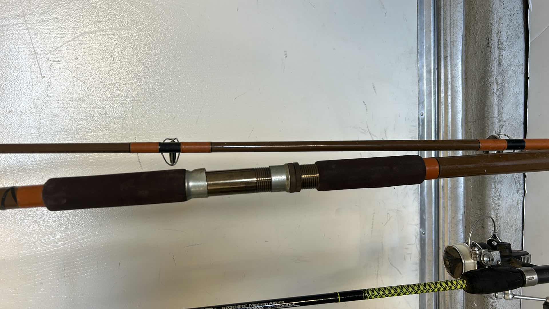 Photo 4 of TWO FISHING RODS AND  1 REEL