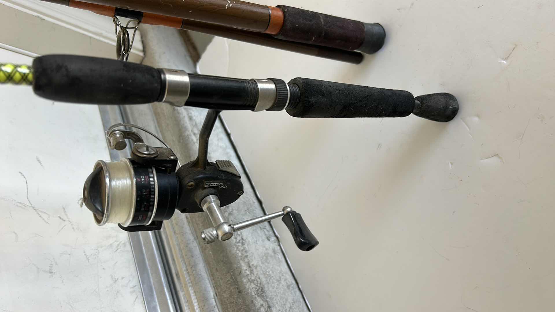 Photo 2 of TWO FISHING RODS AND  1 REEL