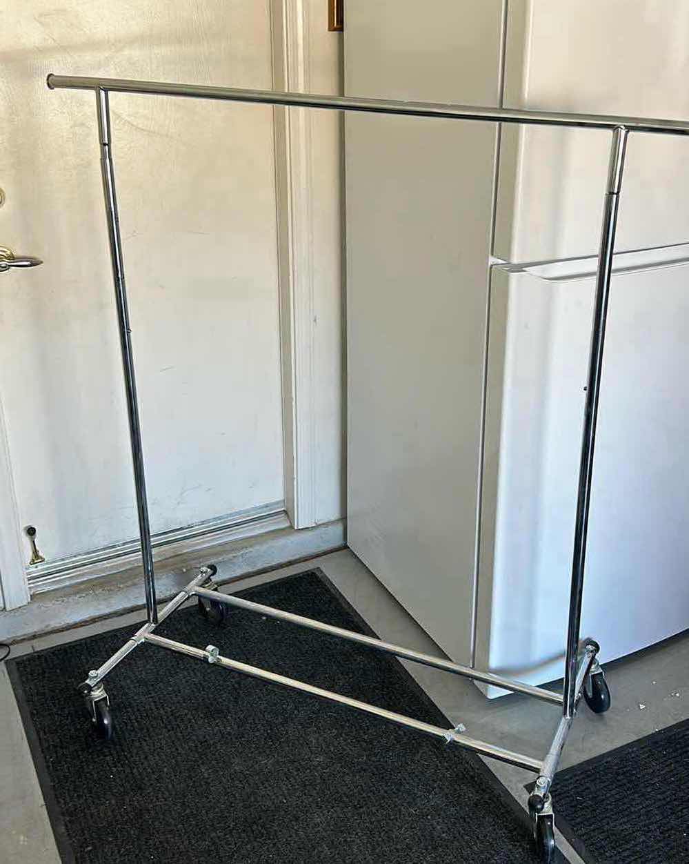 Photo 1 of STURDY, COLLAPSIBLE CLOTHING RACK ON WHEELS.