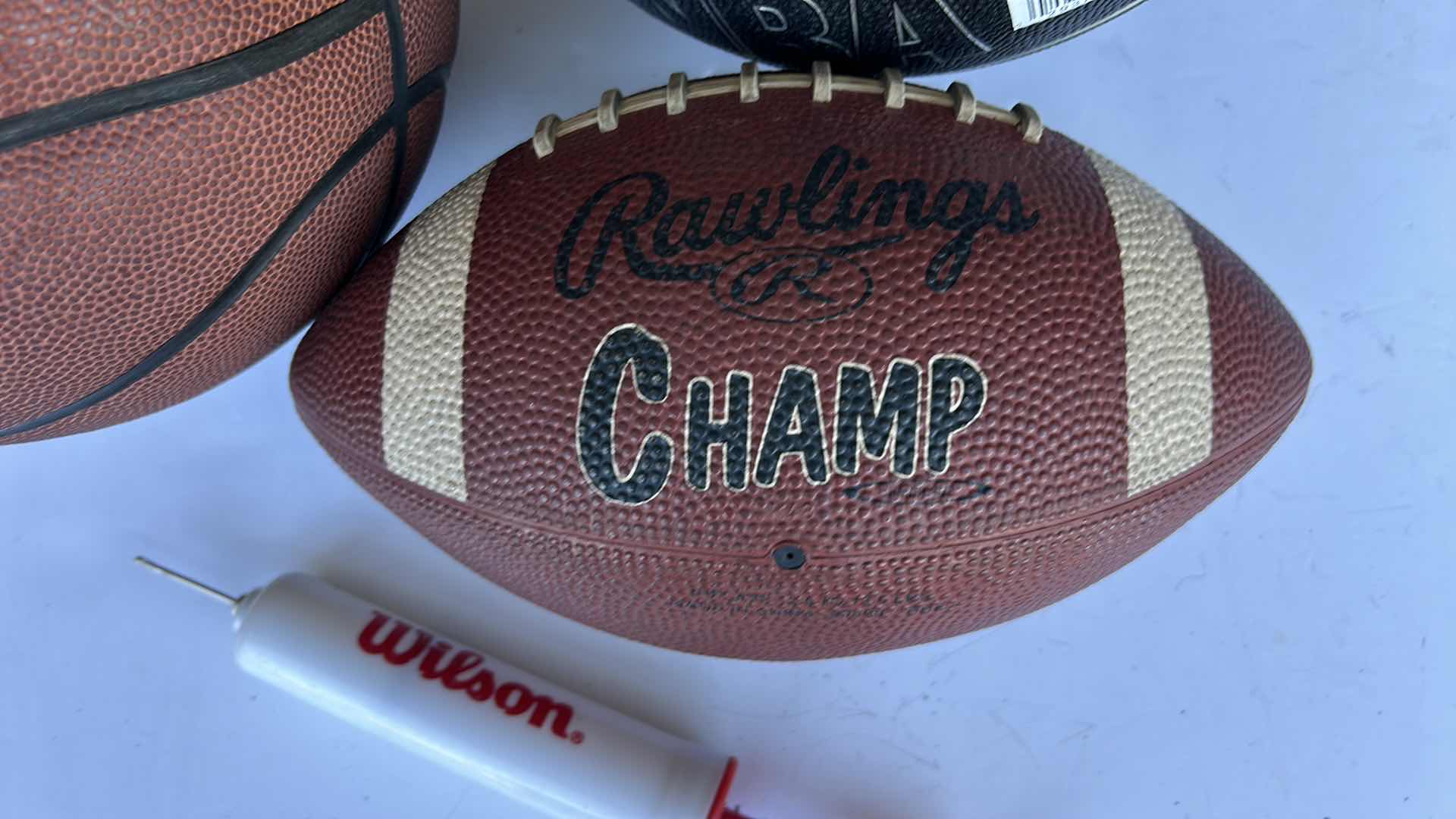 Photo 3 of TWO BASKETBALLS, ONE FOOTBALL, AND A PUMP.