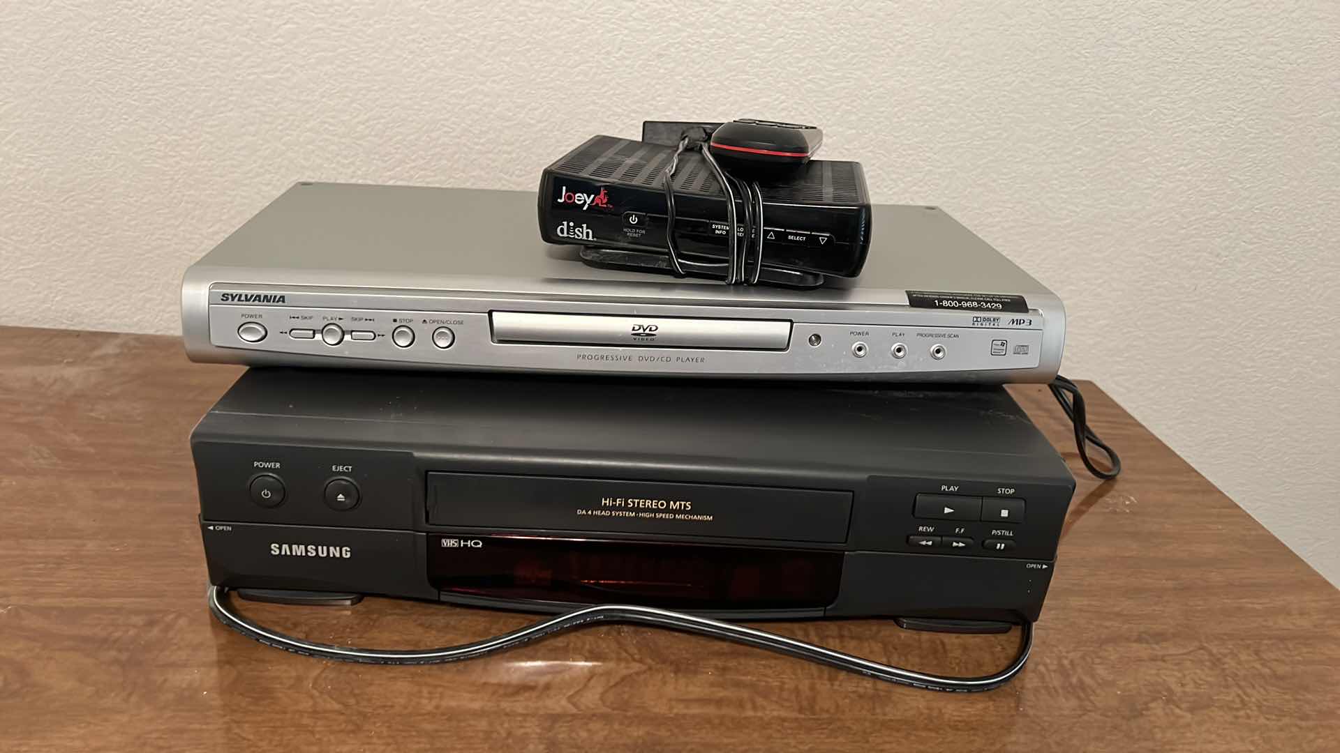 Photo 1 of HOME ELECTRONICS (SAMSUNG VHS PLAYER, SYLVANIA DVD PLAYER & DISH BOX W REMOTE)