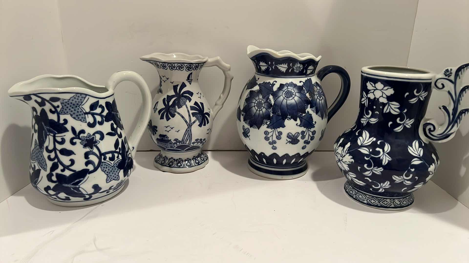 Photo 1 of 4-BLUE & WHITE CERAMIC PITCHERS (TALLEST HEIGHT 8”)