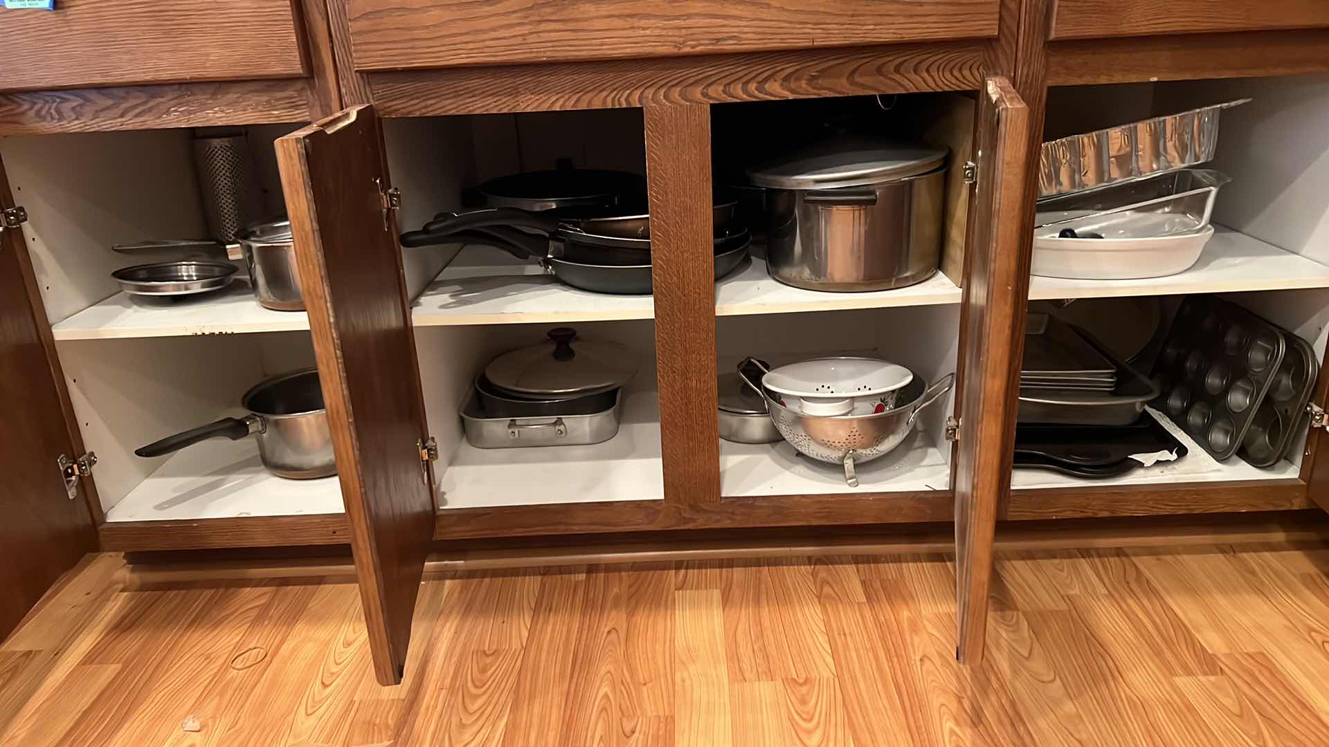 Photo 1 of CONTENTS OF 3-BOTTOM KITCHEN CABINETS-POTS & PANS
