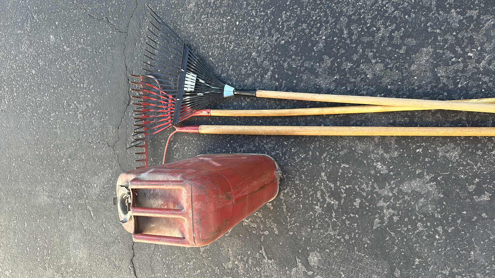 Photo 1 of THREE RAKES AND METAL FUEL TANK WITH LIQUID INSIDE