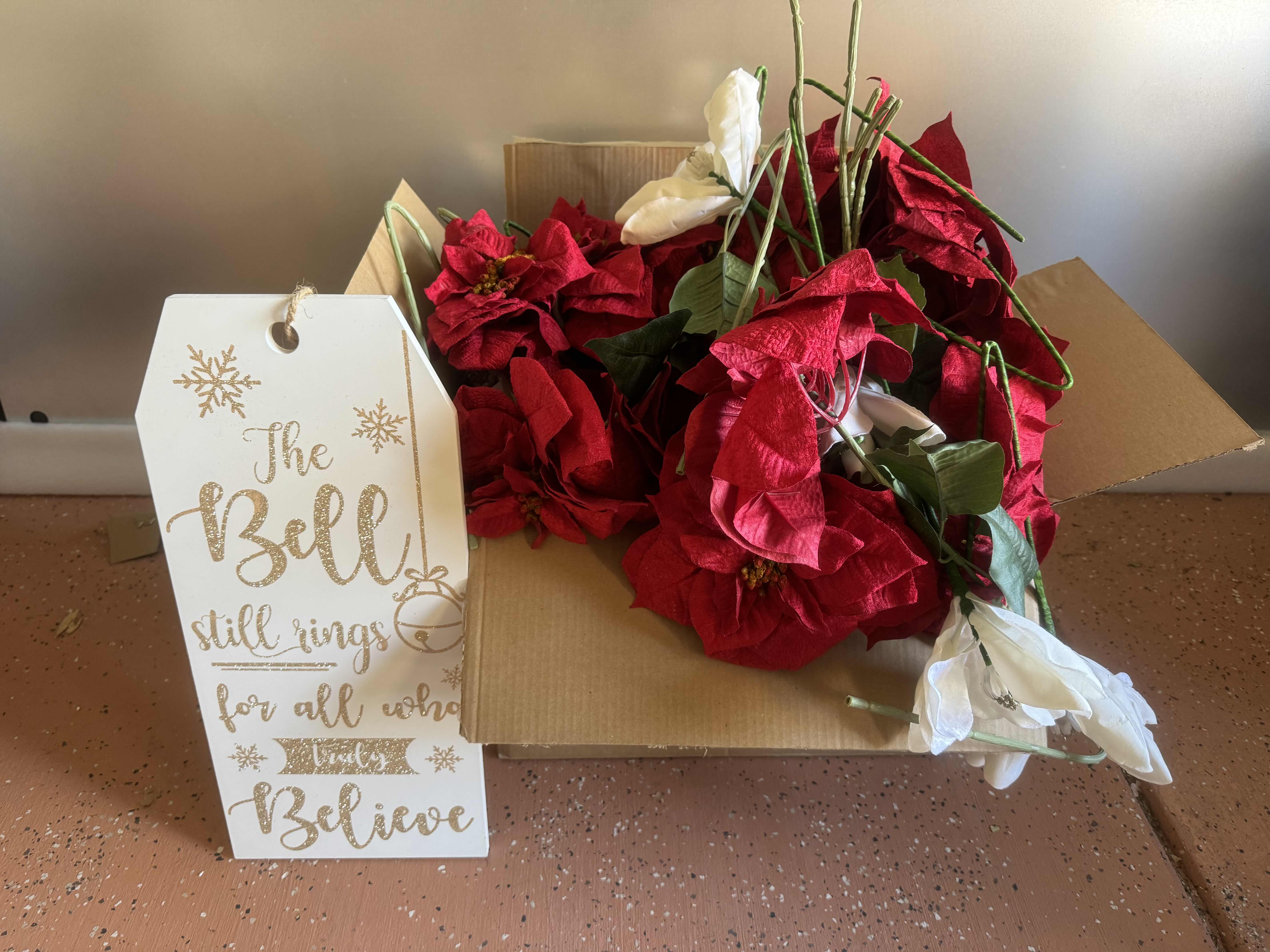 Photo 1 of BOX OF POINSETTIAS AND ONE HOLIDAY SIGN 9” X 20”