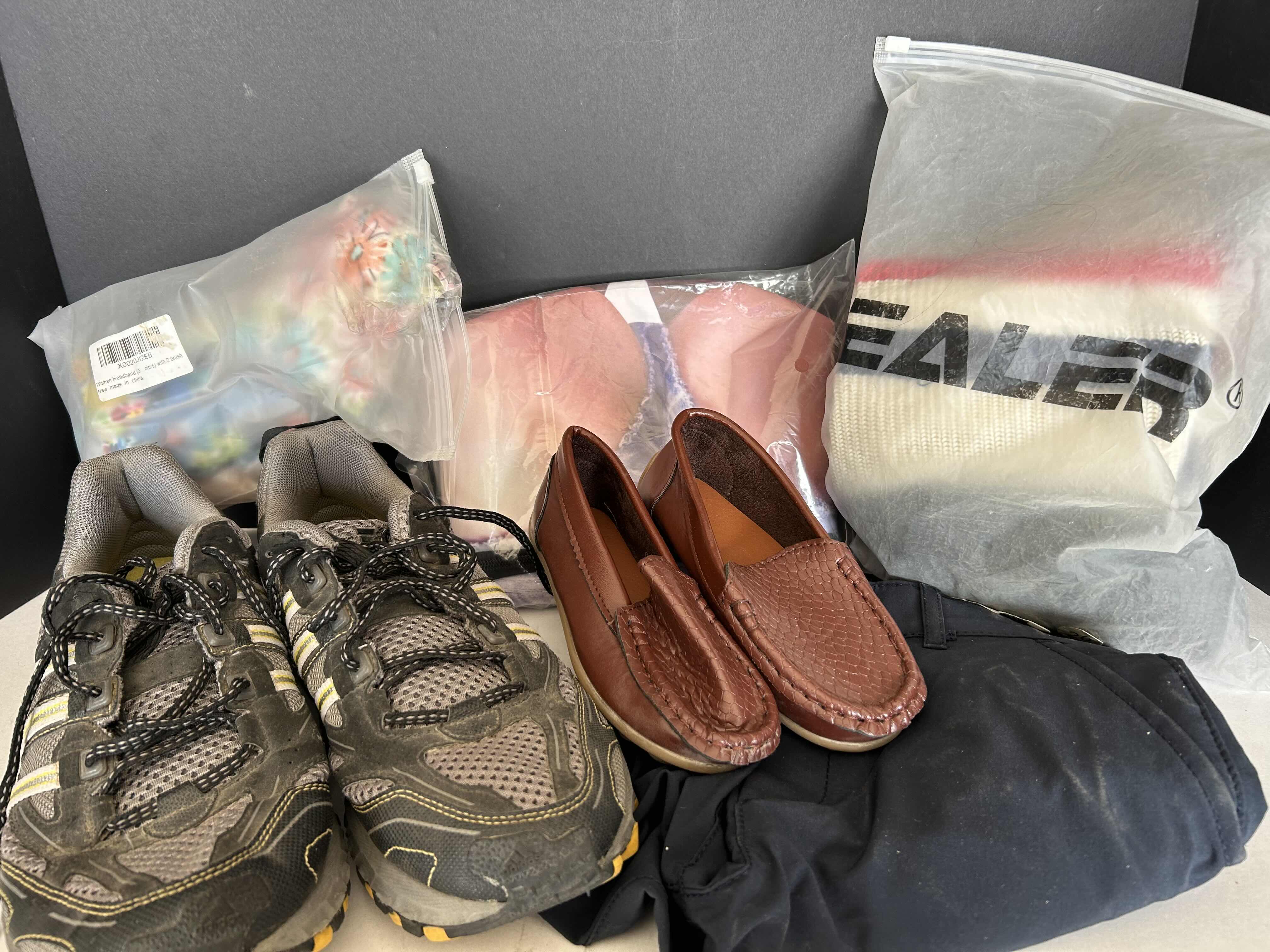 Photo 1 of BAG OF VARIOUS CLOTHING ITEMS (SHOES, HEADBANDS, FANNY PACK, SHORTS)