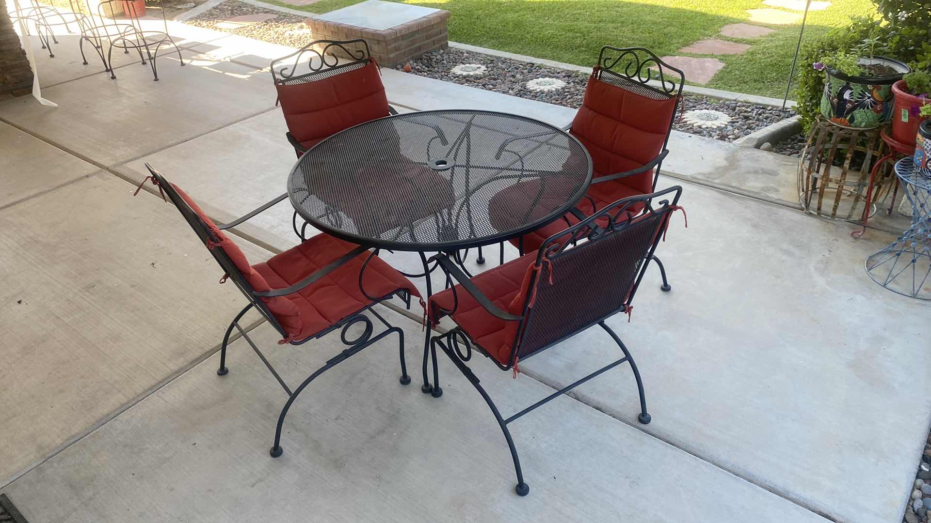 Photo 2 of BLACK MESH METAL 5 PIECE PATIO SET TABLE 44“ x 29 1/2“ & 4 CHAIRS WITH RED CUSHIONS