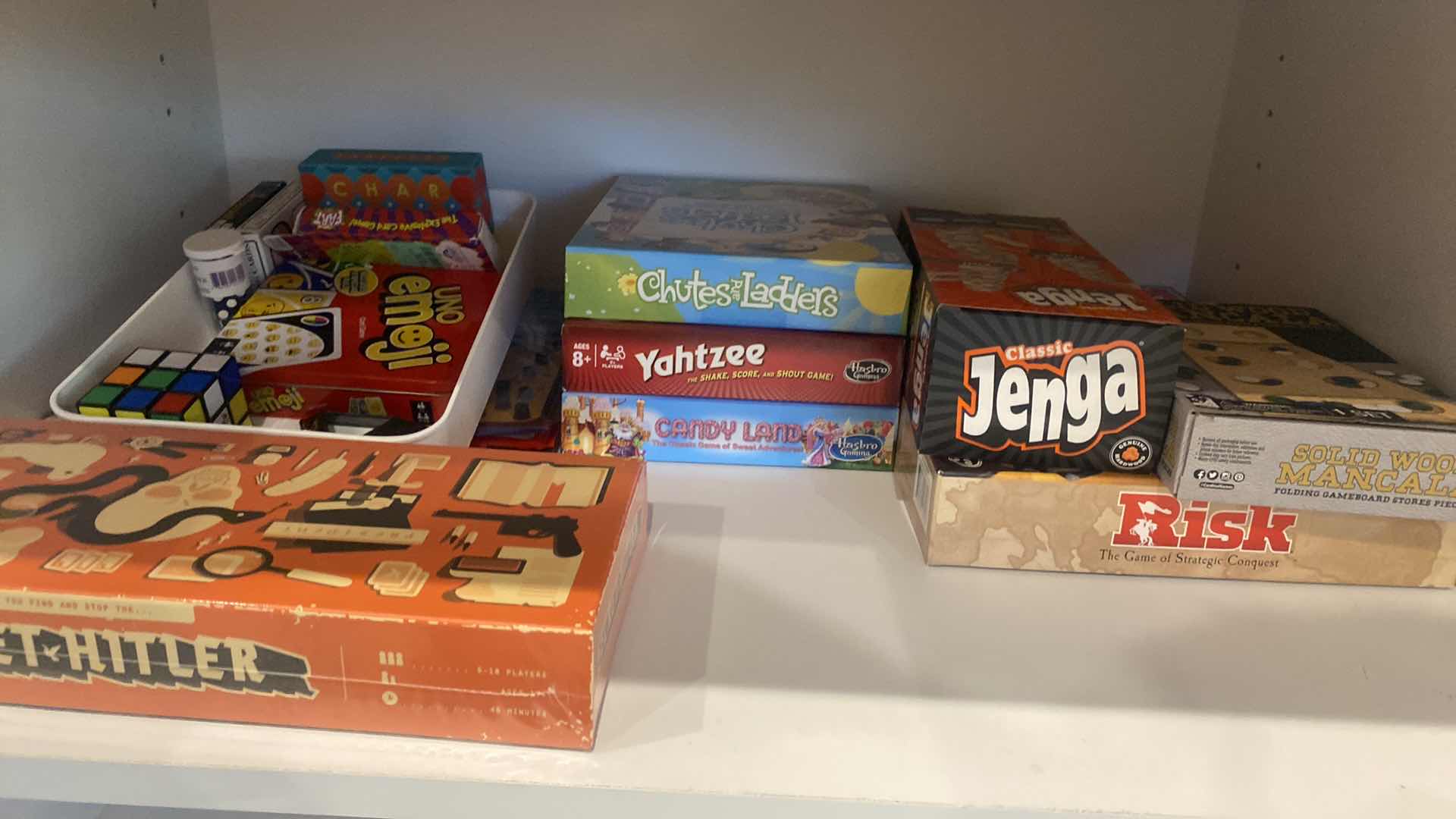 Photo 1 of CONTENTS OF KITCHEN CABINET ASSORTED GAMES