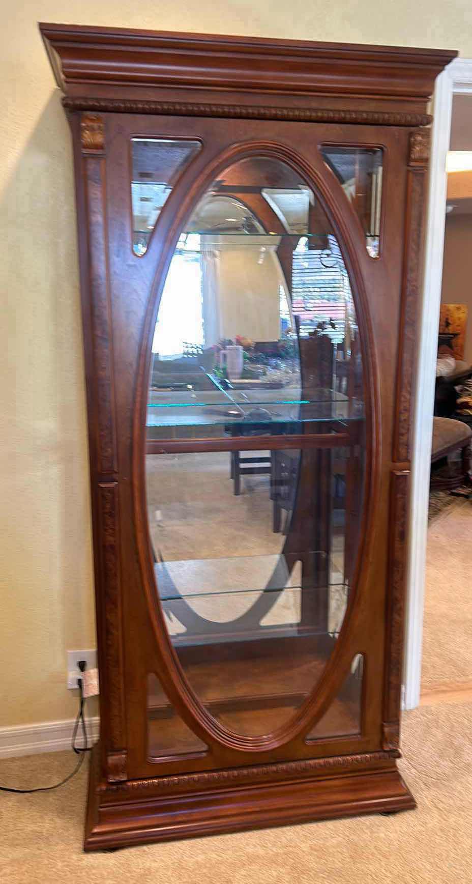 Photo 1 of LIGHTED WOOD CABINET WITH BEVELED GLASS, SLIDING DOOR, AND THREE GLASS SHELVES. 33“ x 15 1/2“ x H77“.