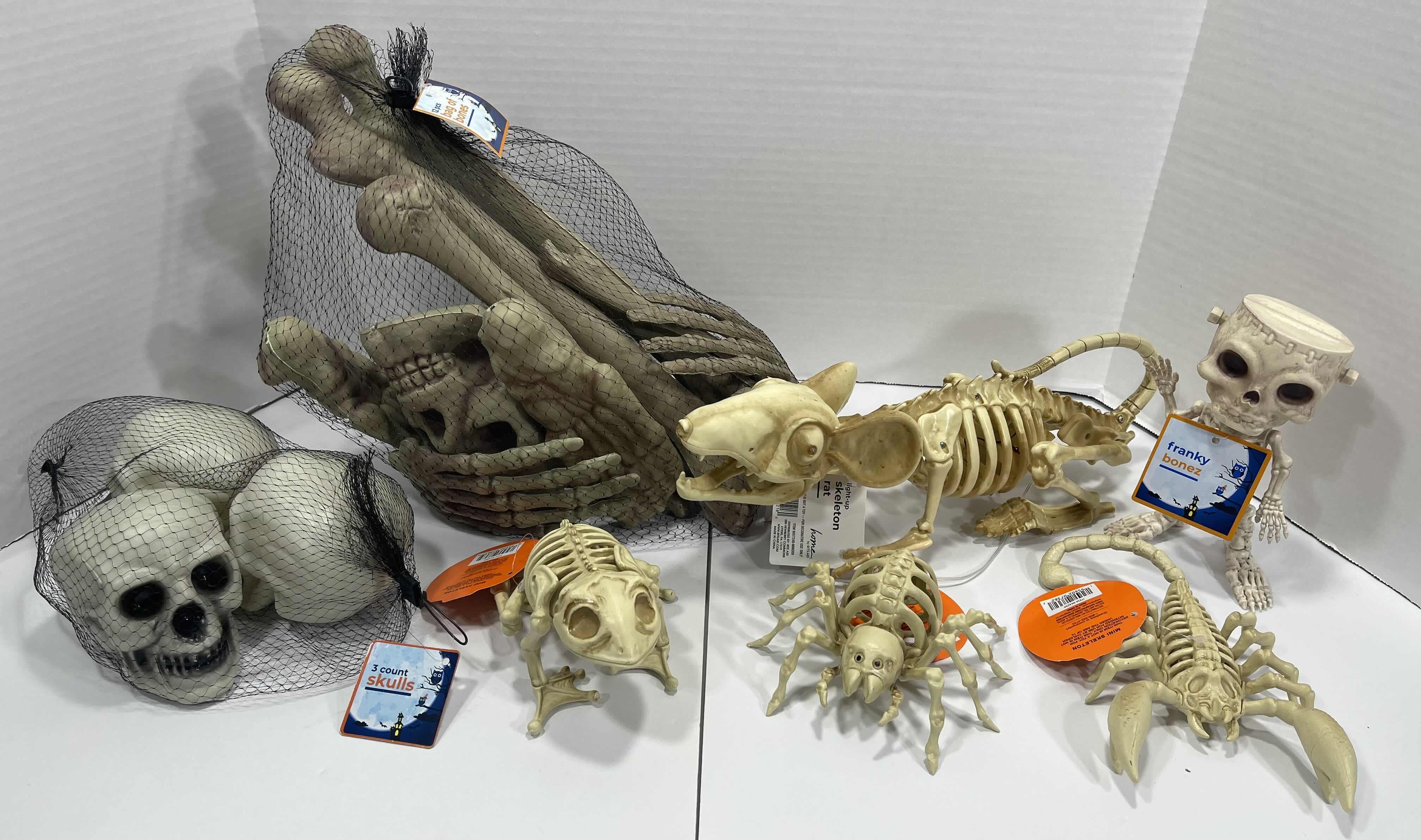 Photo 1 of HALLOWEEN RAT SKELETON LIGHT-UP, 12PCS BAG OF BONES, MINI SKELETONS & SKUKLS YARD/HOME DECORATIONS (7 ITEMS) MSRP $90