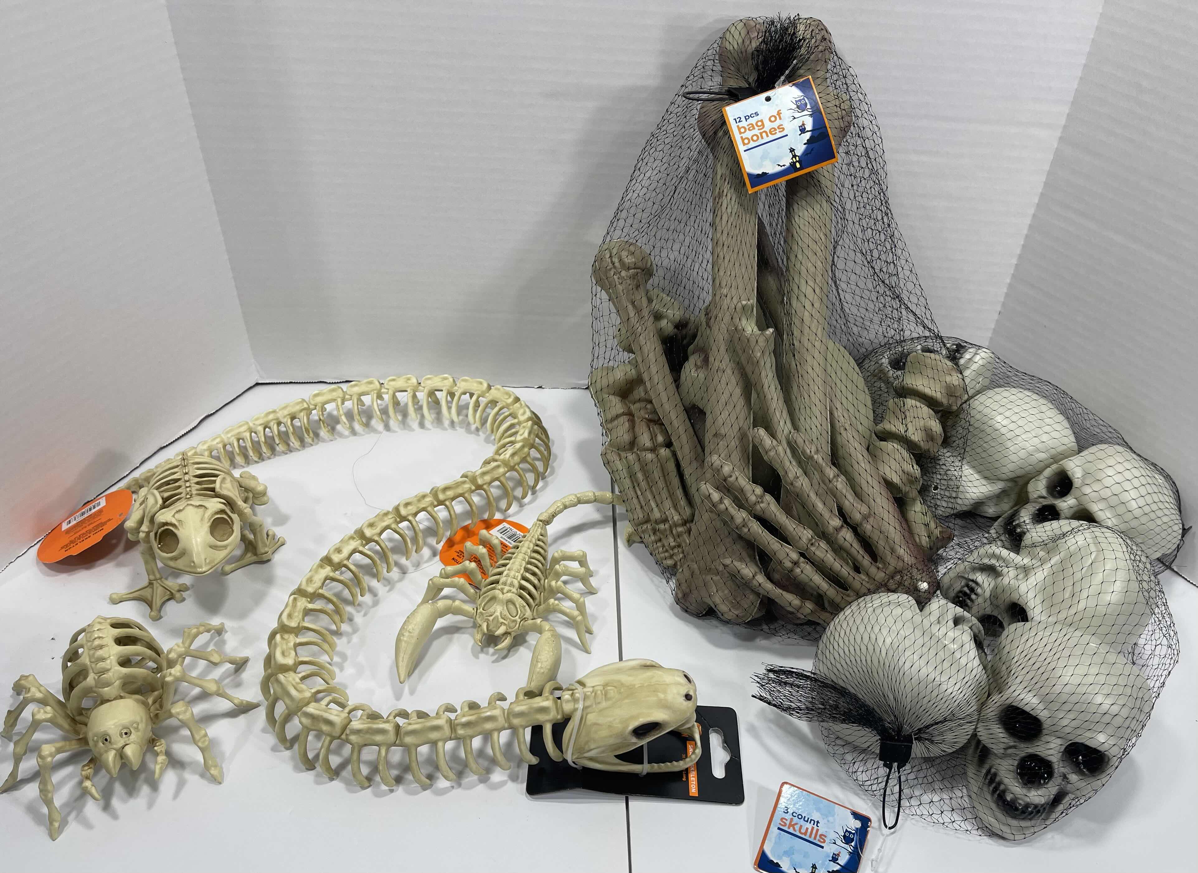 Photo 1 of HALLOWEEN SNAKE SKELETON 36”, 12PCS BAG OF BONES, MINI SKELETONS & SKUKLS YARD/HOME DECORATIONS (7 ITEMS) MSRP $90