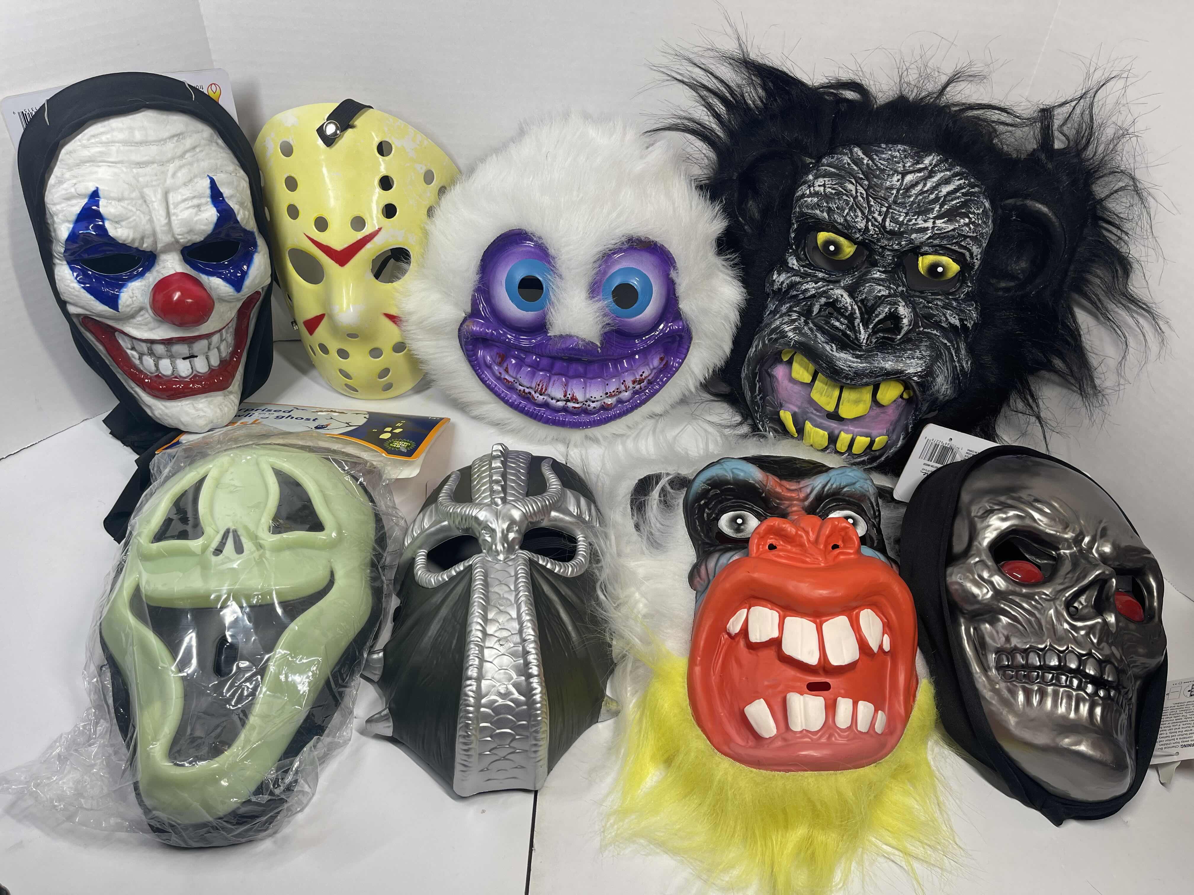 Photo 1 of HALLOWEEN PLASTIC MASKS (8) ONE SIZE FITS MOST ADULTS