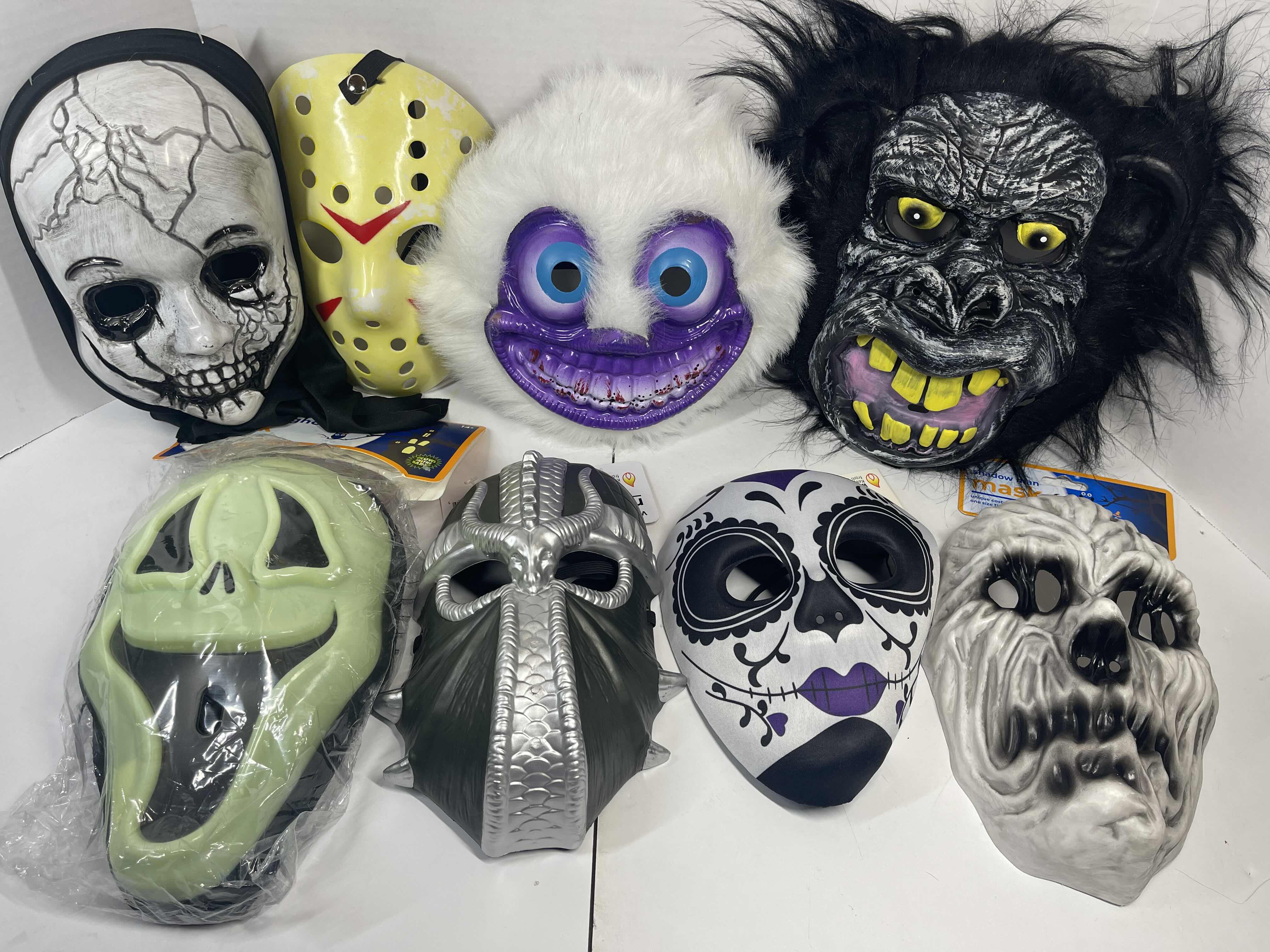 Photo 1 of HALLOWEEN PLASTIC MASKS (8) ONE SIZE FITS MOST ADULTS