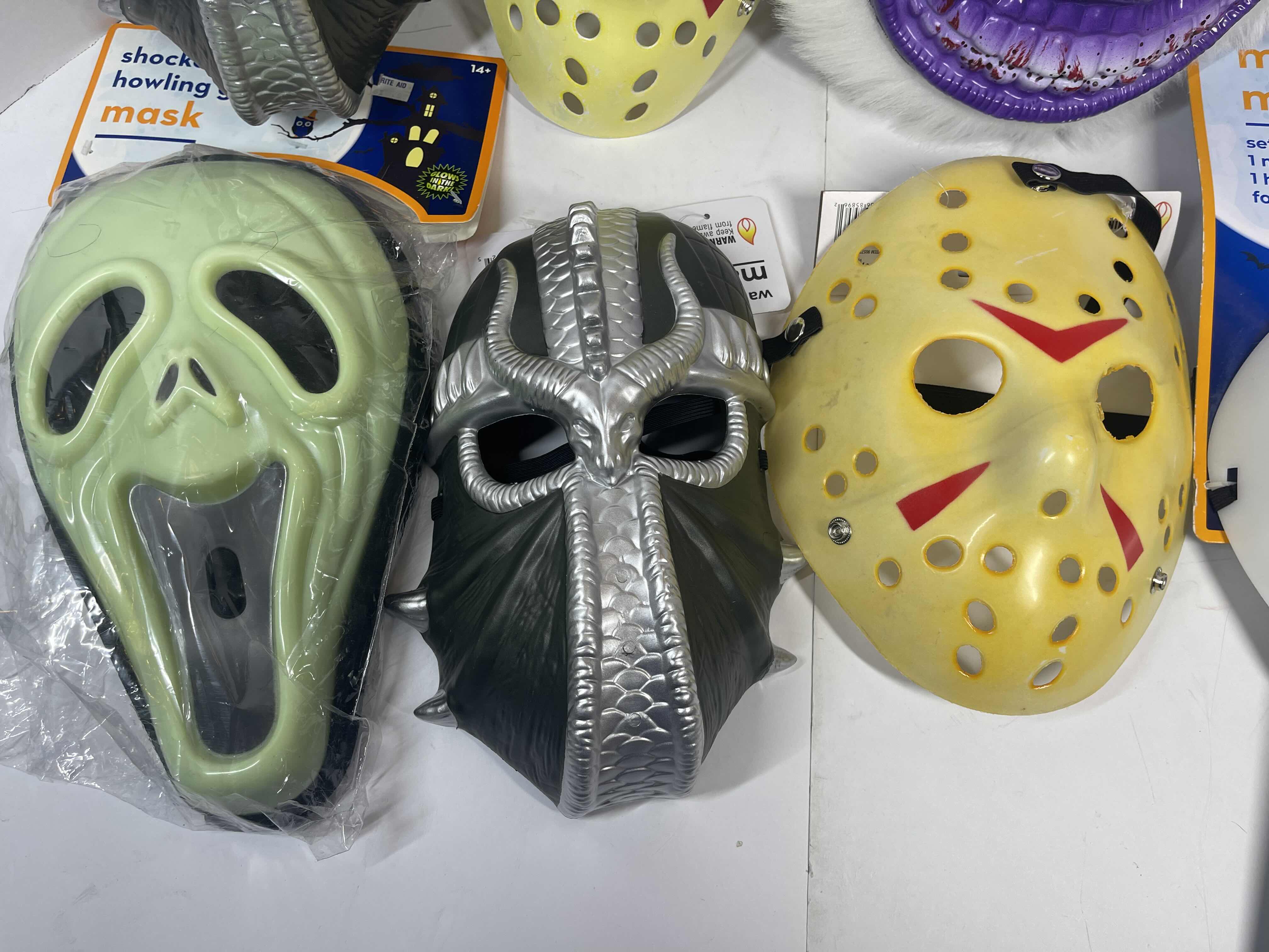 Photo 3 of HALLOWEEN PLASTIC MASKS (7) ONE SIZE FITS MOST ADULTS