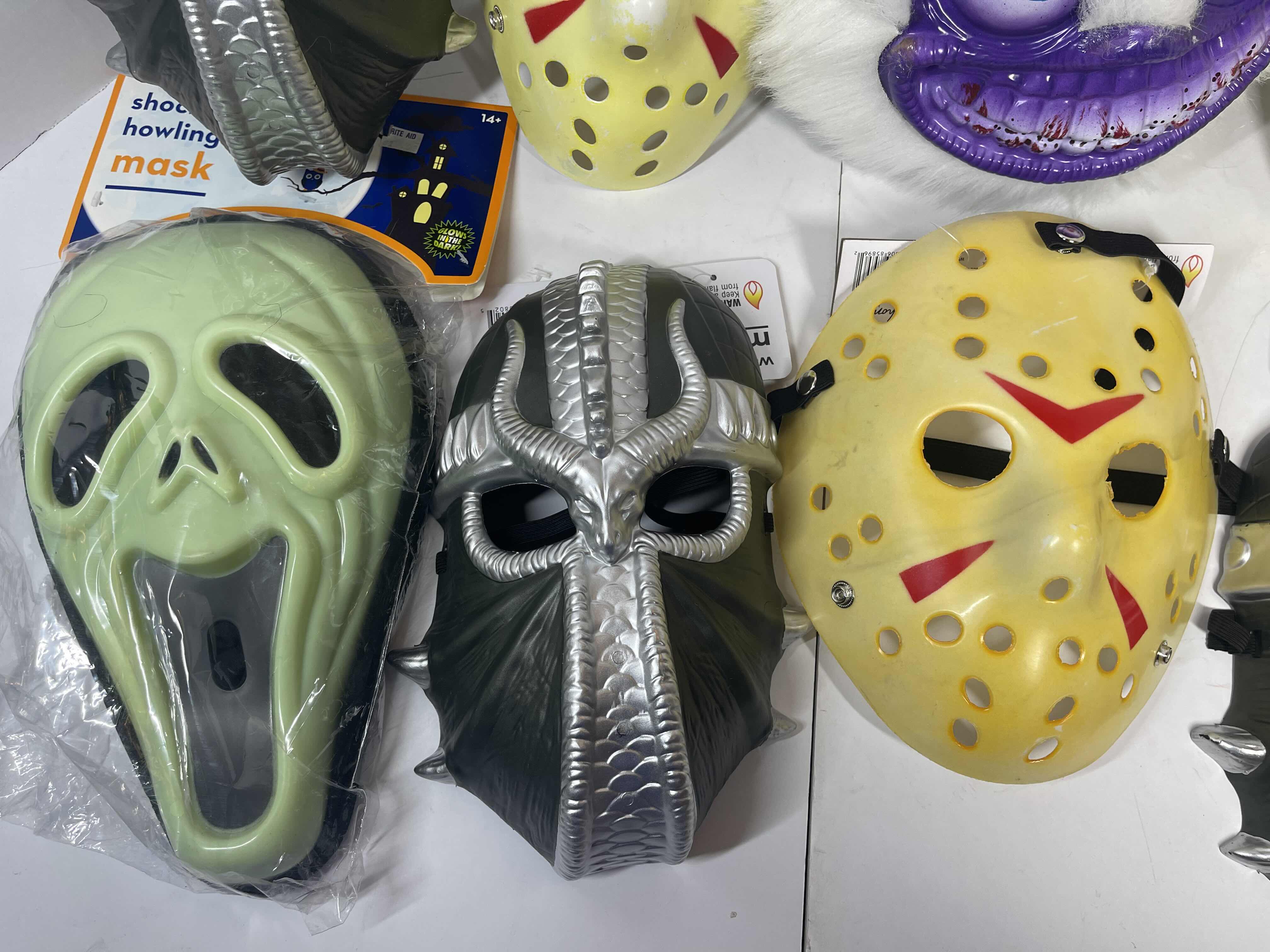 Photo 3 of HALLOWEEN PLASTIC MASKS (8) ONE SIZE FITS MOST ADULTS