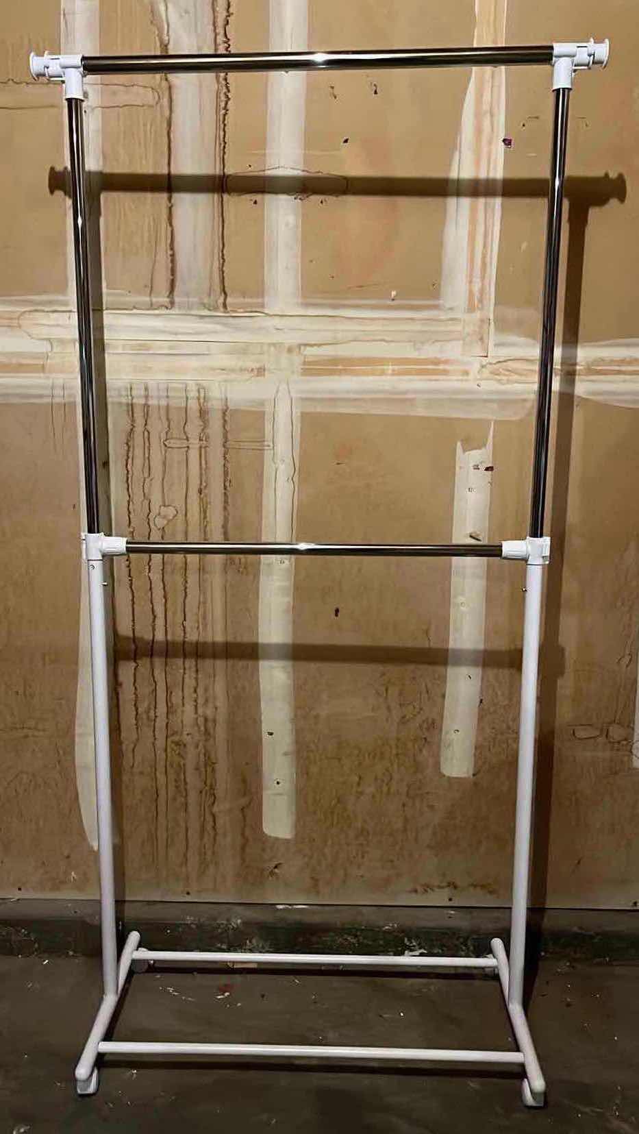 Photo 1 of WHITE & STAINLESS STEEL ROLLING 2 TIER CLOTHING RACK 36.5” X 65.5”