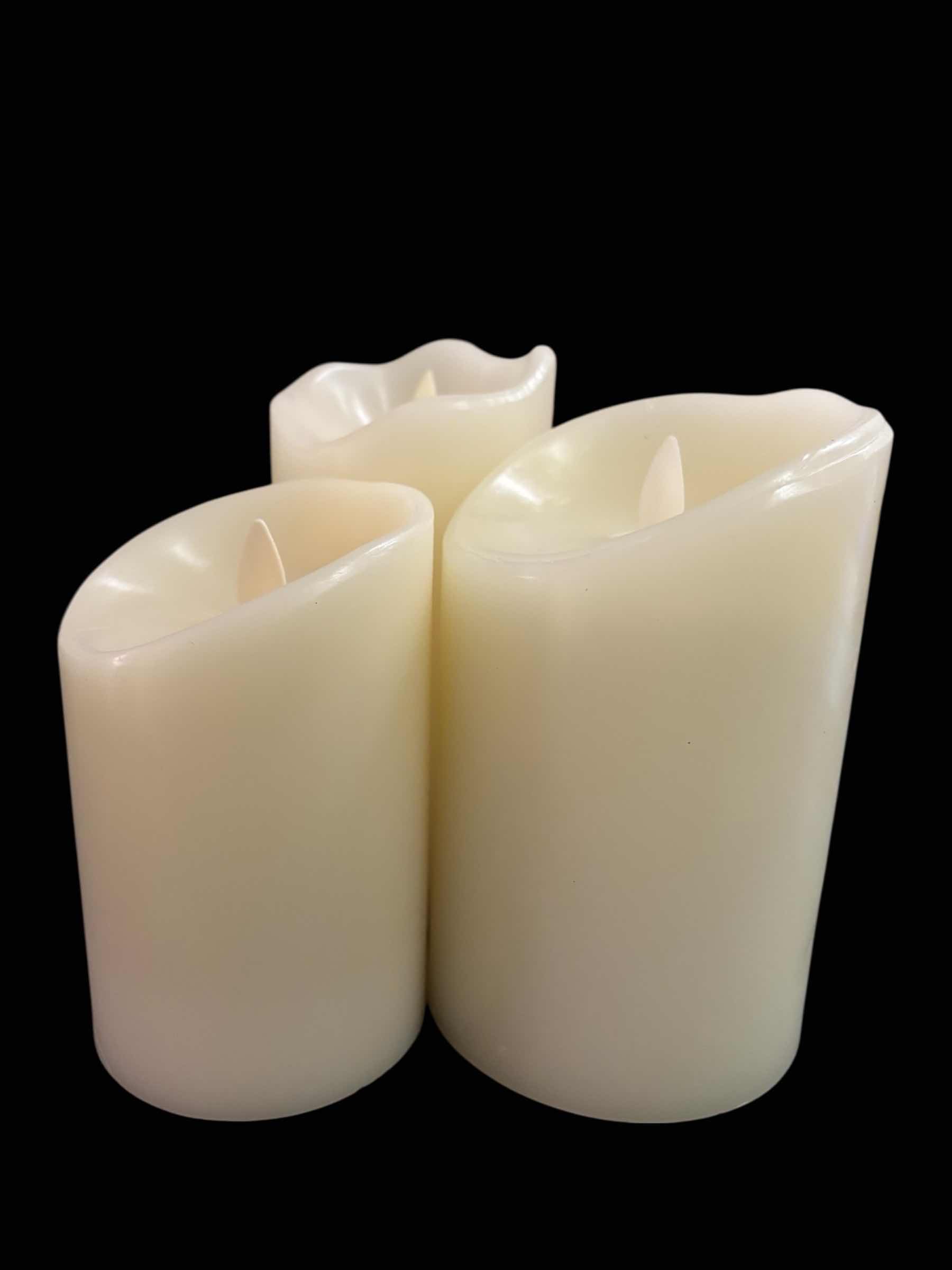 Photo 1 of FLICKERING FLAMELESS LED CANDLES W TIMER SETTING, SET OF 3, IVORY COLOR W MELTED TOP (4.75”, 5.75” & 6”)