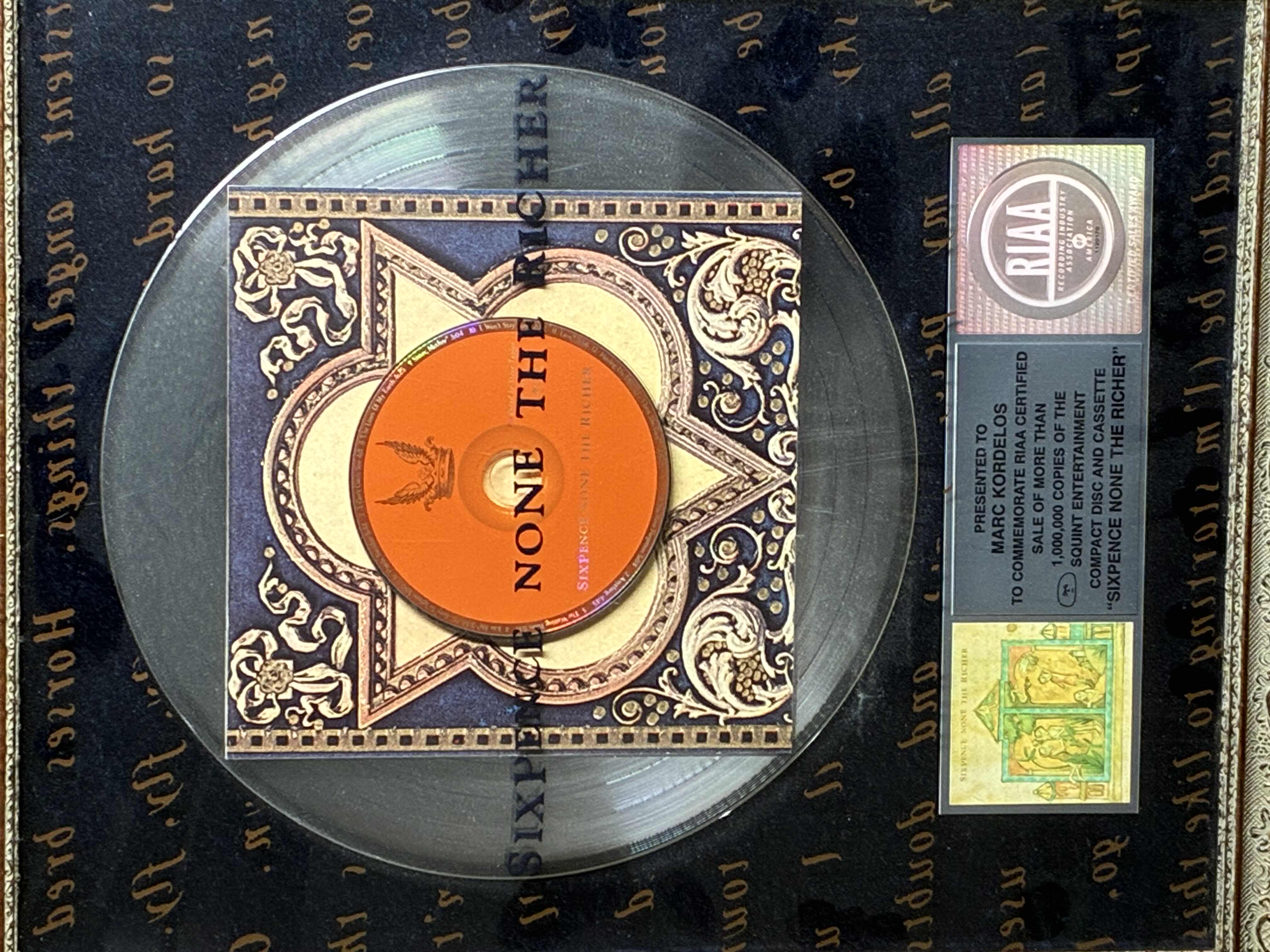 Photo 1 of PLATINUM RECORD PRESENTED TO MARC KORDELOS COMMEMORATE RIAA CERTIFIED SALE OF MORE THAN $1M COPIES OF THE SQUINT ENTERTAINMENT COMPACT DISC & CASSETTE "SIXPENCE NONE THE RICHER" FRAMED PLAQUE 17“ X 21“