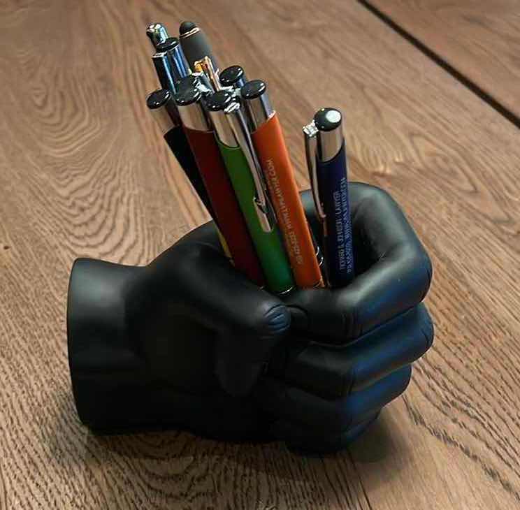 Photo 1 of BLACK DENSE PLASTIC CLOSED FIST PEN HOLDER. H3” 