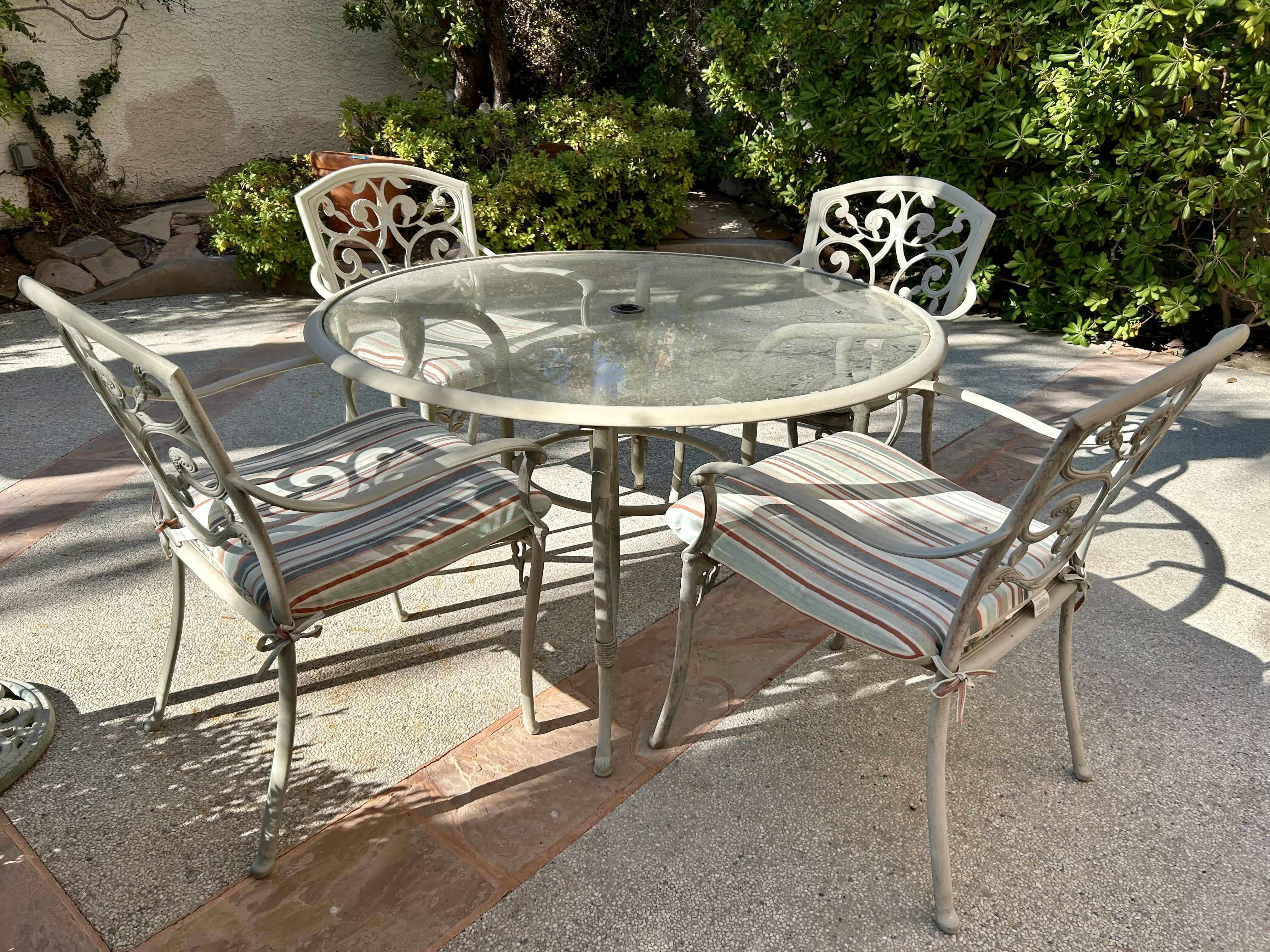 Photo 2 of 50” METAL PATIO TABLE SET WITH GLASS TOP AND 4 CHAIRS WITH STRIPED CUSHIONS