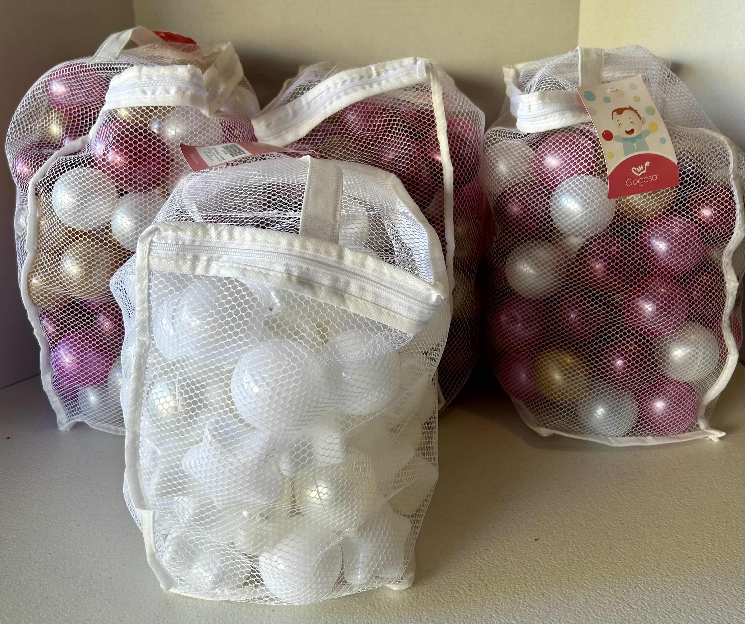 Photo 1 of 4-BAGS OF BALL PIT BALLS IN PINK, WHITE, AND GOLD -SOME STAR SHAPES