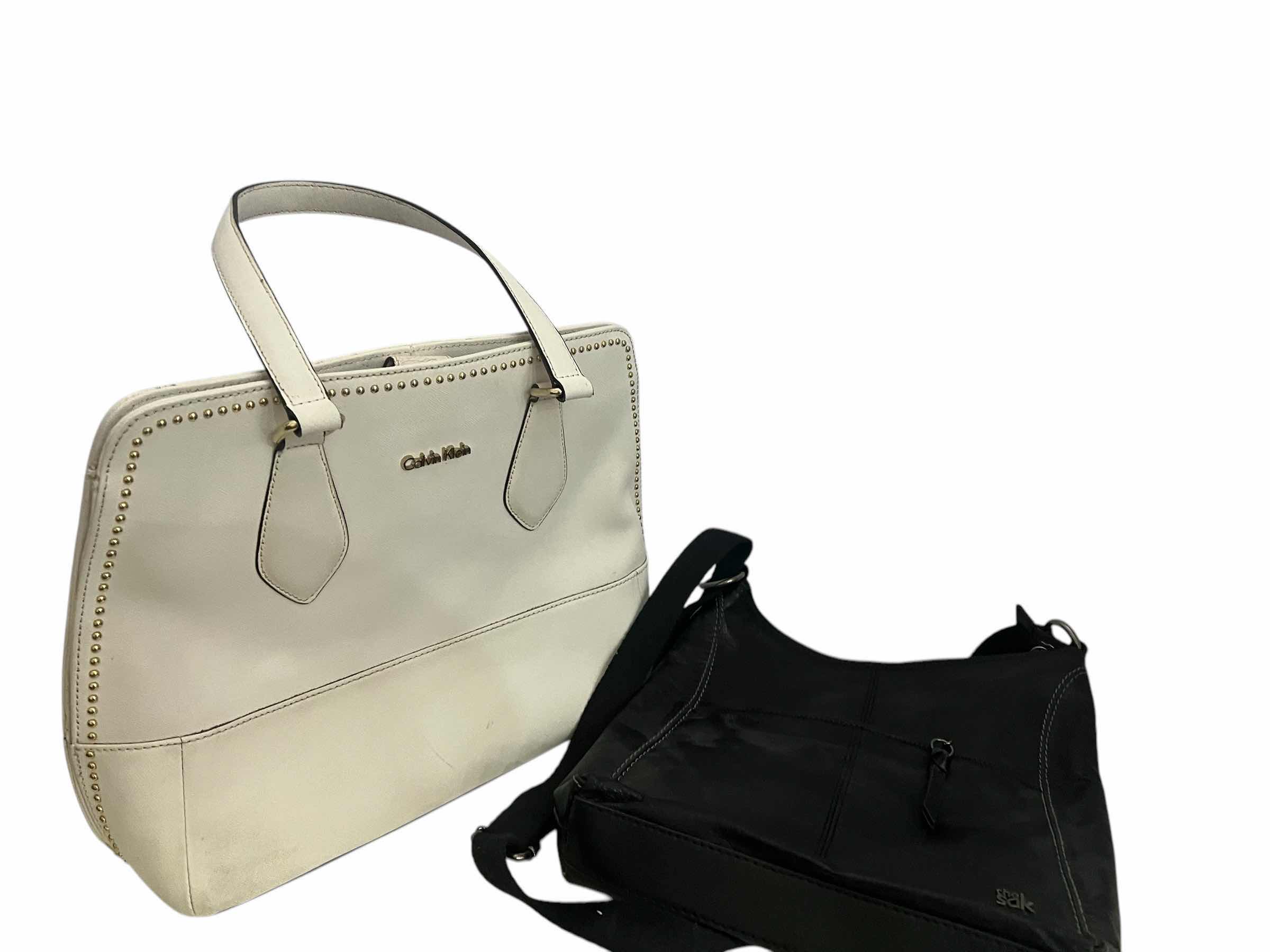 Photo 1 of 2- DESIGNER PURSES. WHITE "CALVIN KLEIN" AND  BLACK "THE SAK" BAGS.