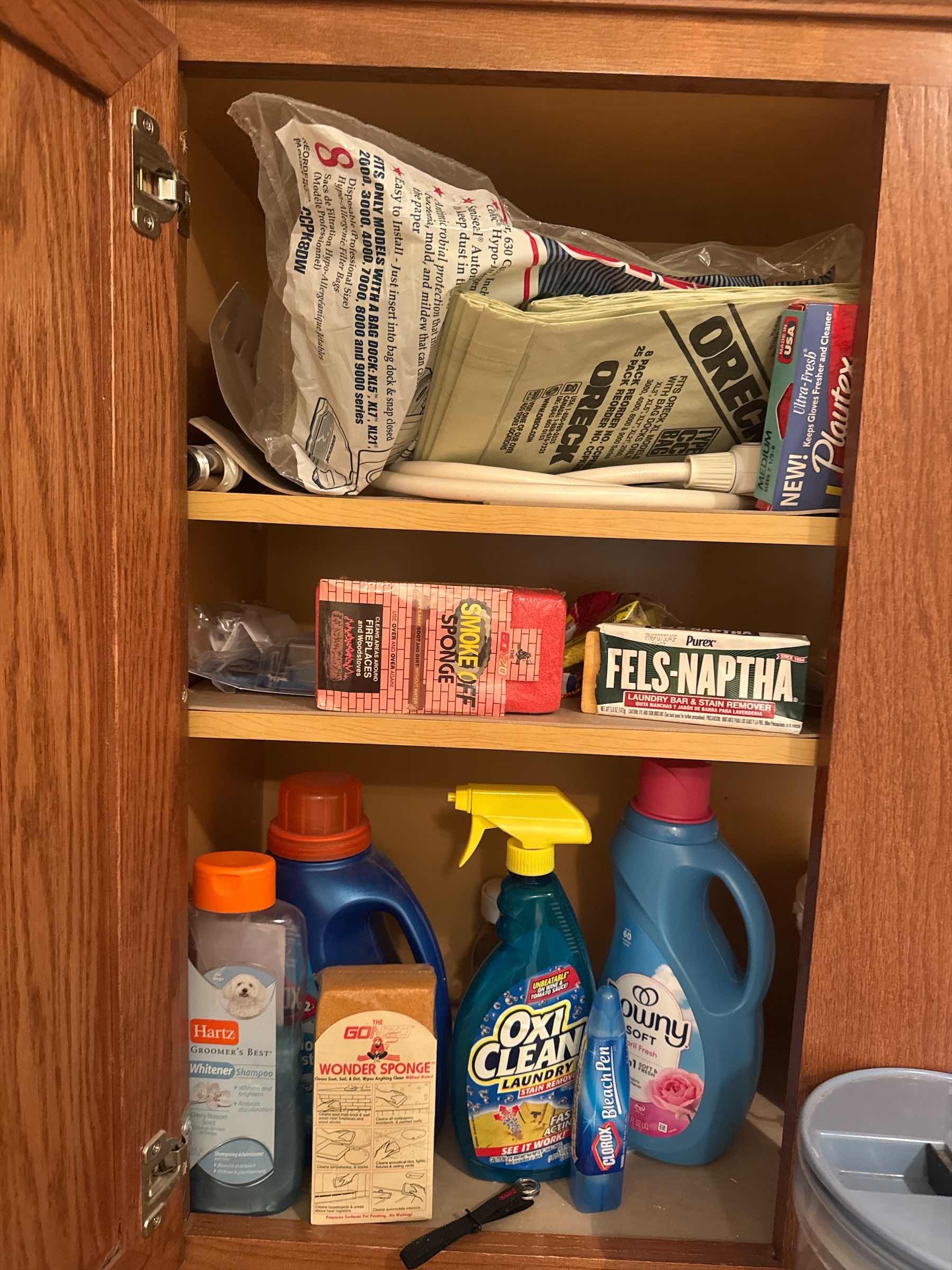 Photo 1 of CONTENTS OF CABINET: ORECK VACUUM BAGS, LAUNDRY SOAP, BLEACH