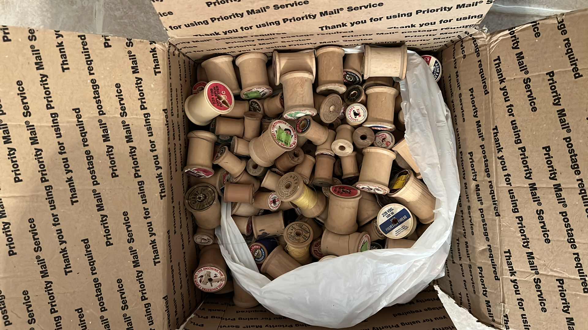 Photo 1 of BOX OF ANTIQUE WOODEN THREAD SPOOLS