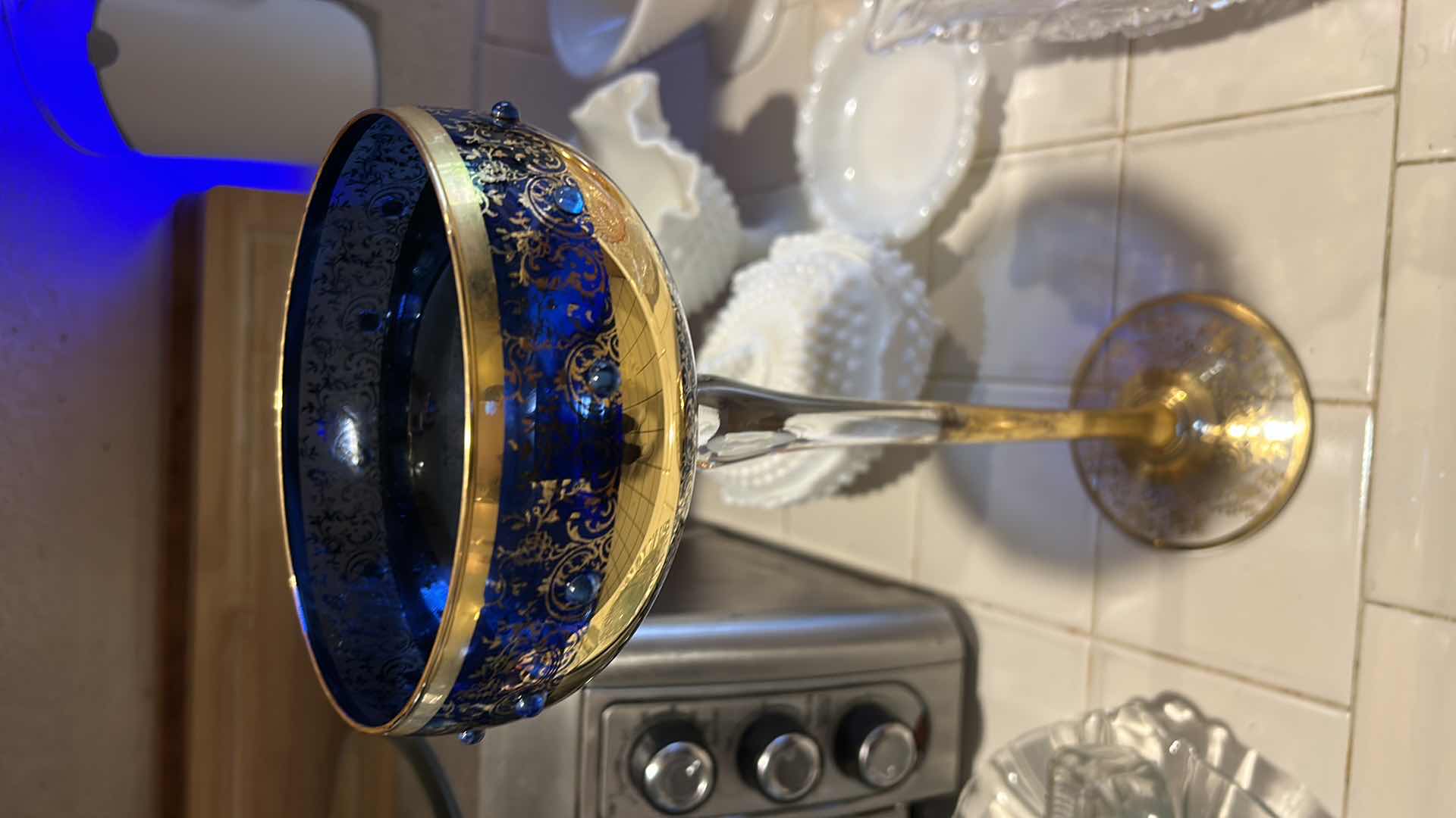 Photo 1 of 2 VINTAGE BOHEMIAN-STYLE COBALT AND GILT ART GLASS PEDESTAL COMPOTE / GOBLET, FEATURING HEAVY GOLD ENCRUSTED FLORAL DECORATION WITH COBALT BLUE JEWELED CABOCHON ACCENTS, CLEAR STEM, AND GILT FOOT, APPROX. H13” & BOHEMIAN CZECH COBALT BLUE GLASS BOWL,