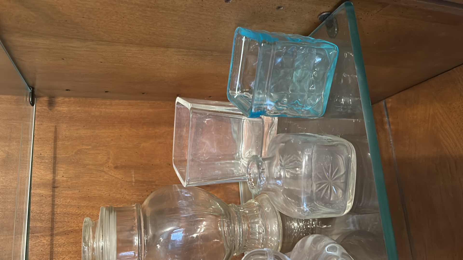 Photo 1 of 12 GLASS PIECES- VINTAGE GLASSWARE INCLUDES A VARIETY OF CLEAR GLASS LIDDED JARS, VASES, AND BOTTLES FROM THE 1950S TO THE 1970S.