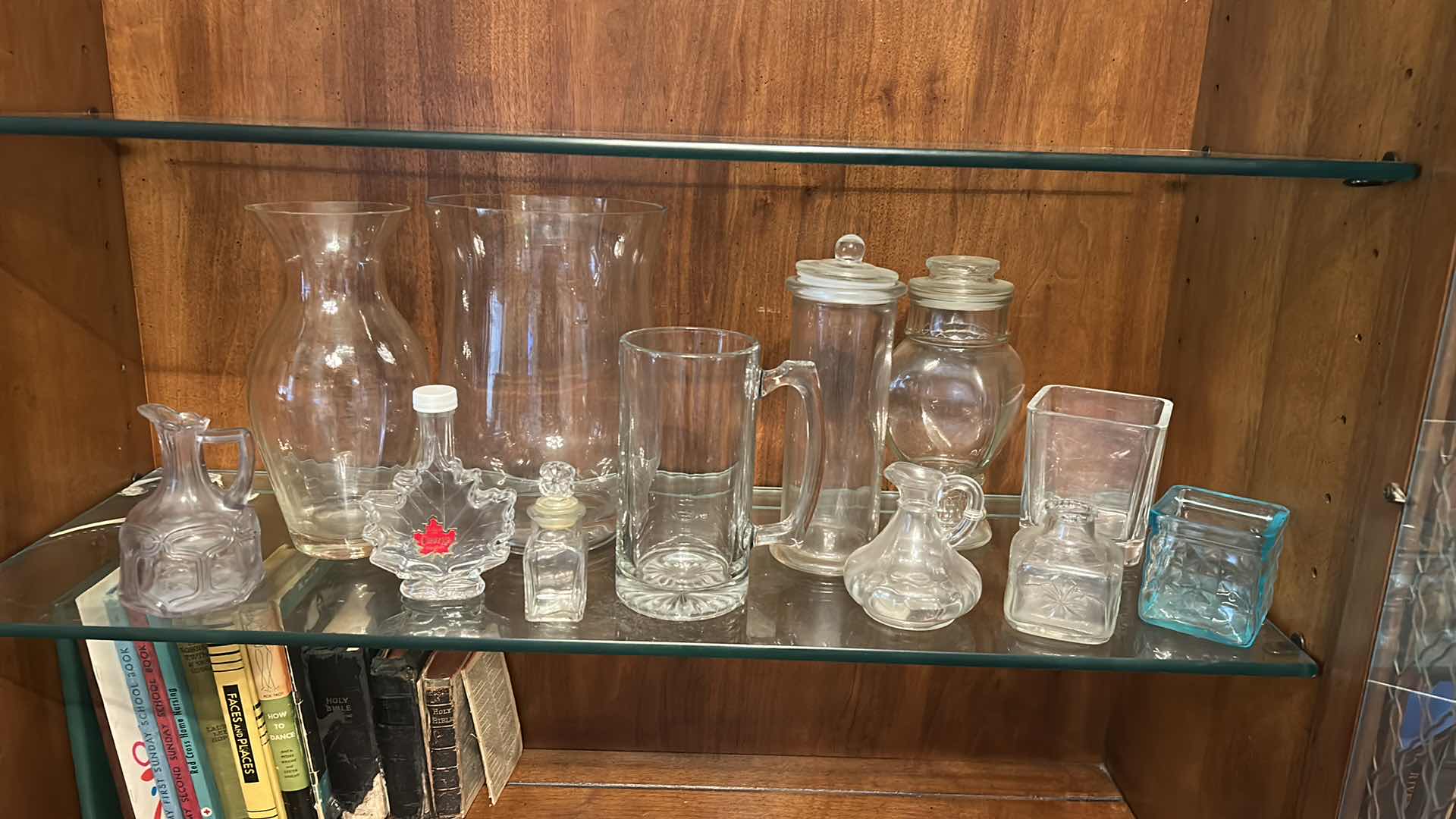Photo 1 of 12 GLASS PIECES- VINTAGE GLASSWARE INCLUDES A VARIETY OF CLEAR GLASS LIDDED JARS, VASES, AND BOTTLES FROM THE 1950S TO THE 1970S.