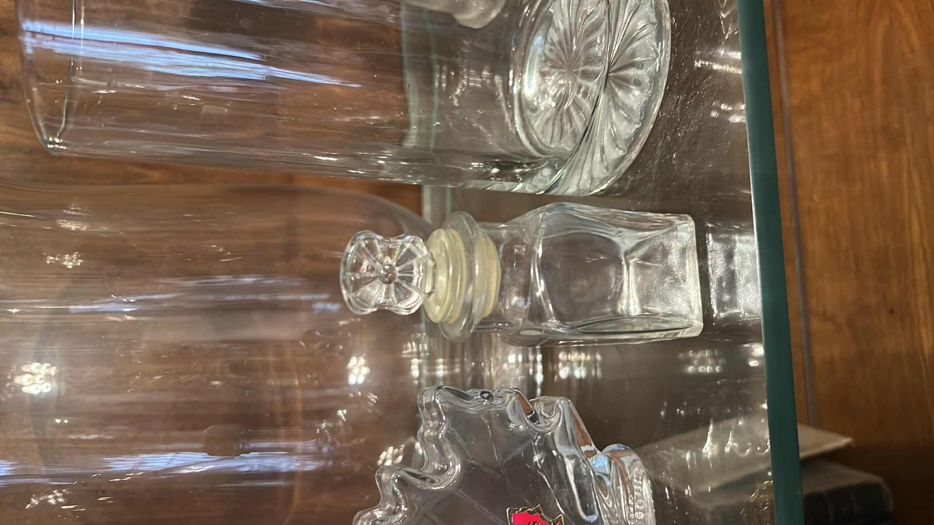 Photo 1 of 12 GLASS PIECES- VINTAGE GLASSWARE INCLUDES A VARIETY OF CLEAR GLASS LIDDED JARS, VASES, AND BOTTLES FROM THE 1950S TO THE 1970S.