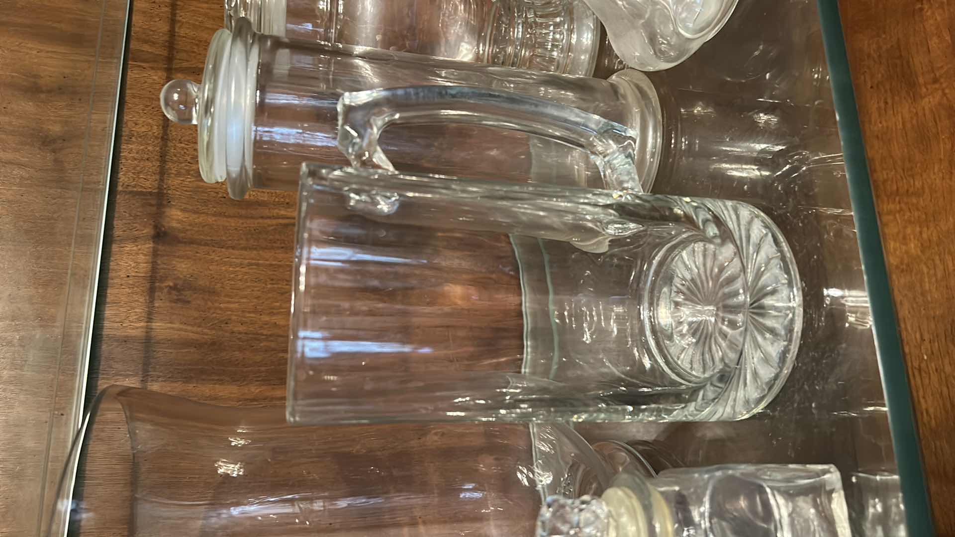 Photo 1 of 12 GLASS PIECES- VINTAGE GLASSWARE INCLUDES A VARIETY OF CLEAR GLASS LIDDED JARS, VASES, AND BOTTLES FROM THE 1950S TO THE 1970S.