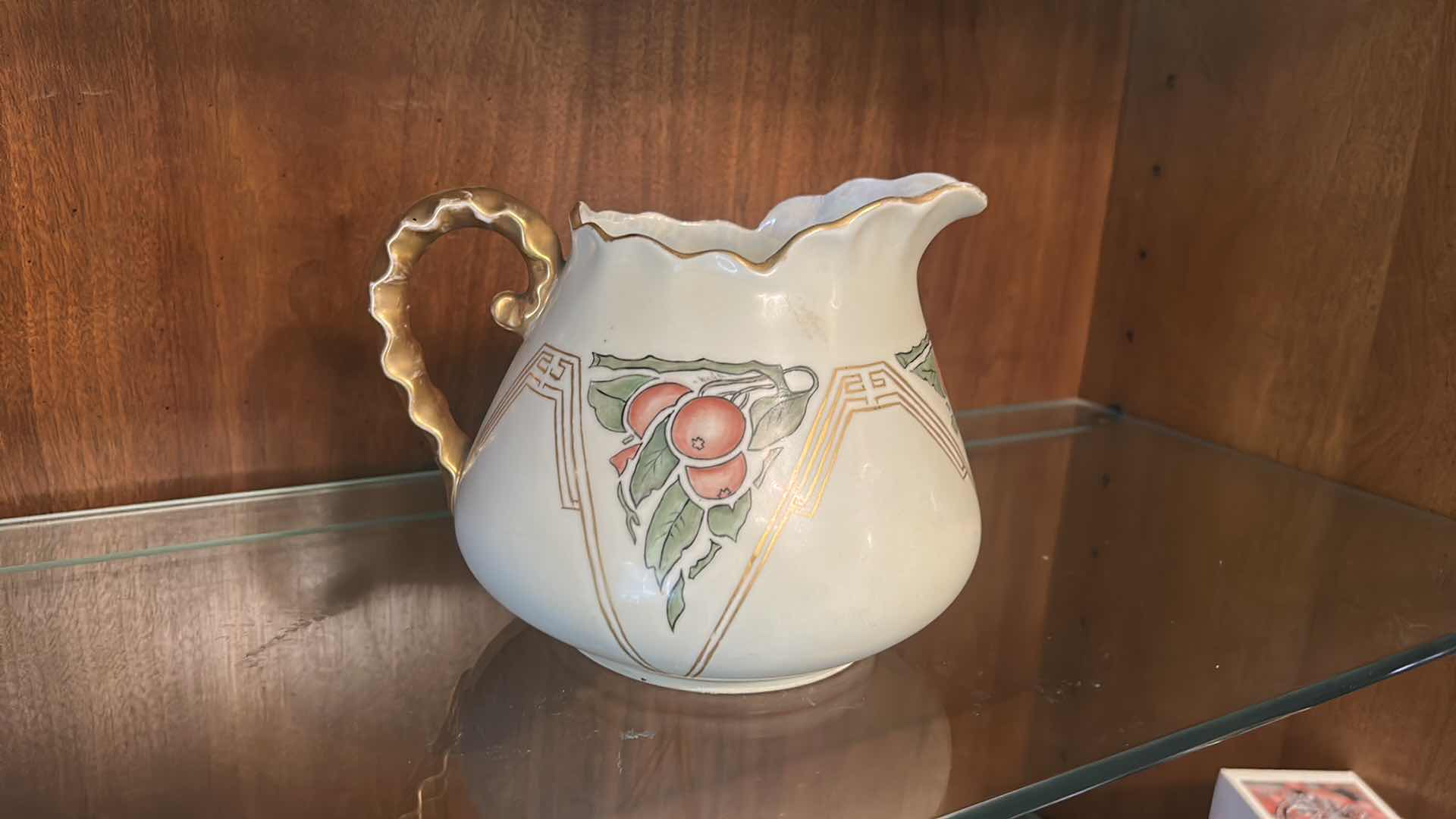Photo 1 of ANTIQUE PORCELAIN WATER PITCHER OR CIDER JUG, LIKELY PRODUCED IN GERMANY OR FRANCE BETWEEN THE LATE 19TH AND EARLY 20TH CENTURY, FEATURING HAND-PAINTED RED CHERRY DESIGNS AND