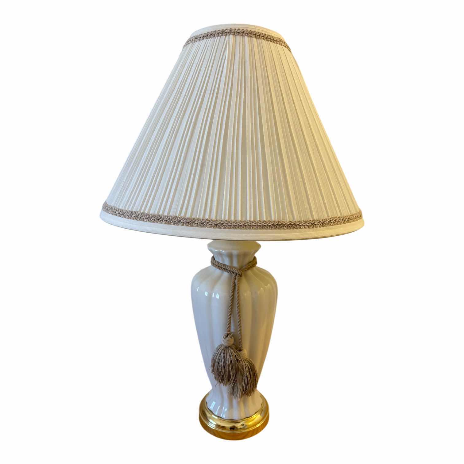 View 1 of BEIGE FINISHED FLUTED CERAMIC BODY W BRASS BASE & PLEATED SHADE TABLE LAMP H29”