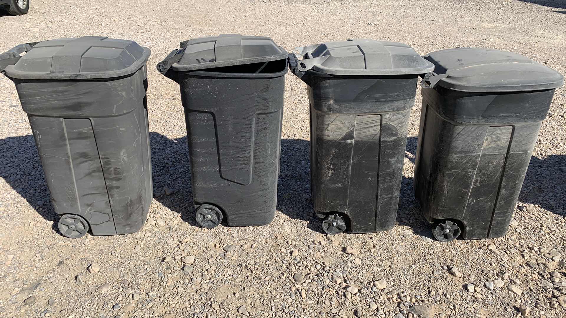 Photo 1 of 4-LARGE PLASTIC ROLLING 48 GALLON TRASH BINS, WITH ATTACHED LIDS.