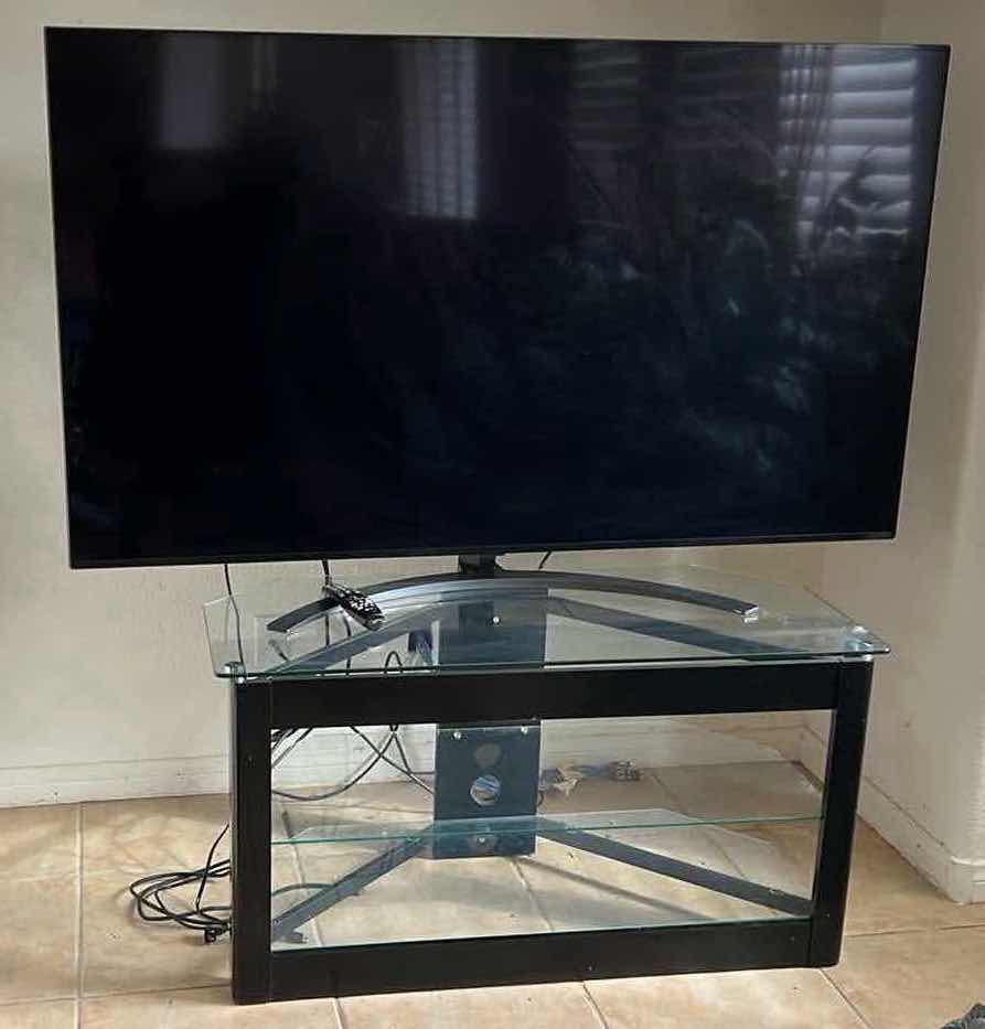 Photo 1 of 65" LG FLATSCREEN TV W REMOTE ON BLACK LAMINATE W GLASS ENTERTAINMENT CENTER