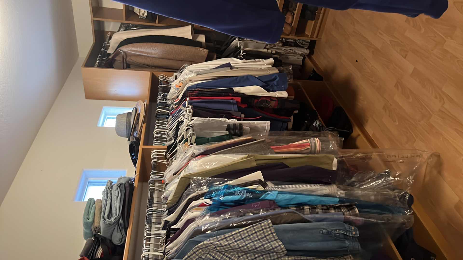 Photo 1 of CONTENTS OF PRIMARY CLOSET MEN'S CLOTHES (AVERAGE SIZE SHIRTS XL, PANTS 36)