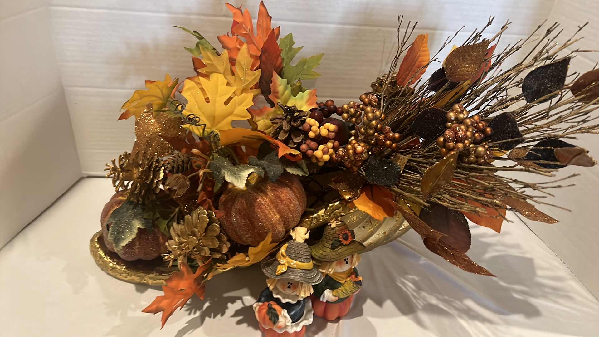 Photo 2 of GOLD METAL CORNUCOPIA FALL FAUX FLORAL ARRANGEMENT W20", 2-WOOD PILGRIM FIGURINES H5"