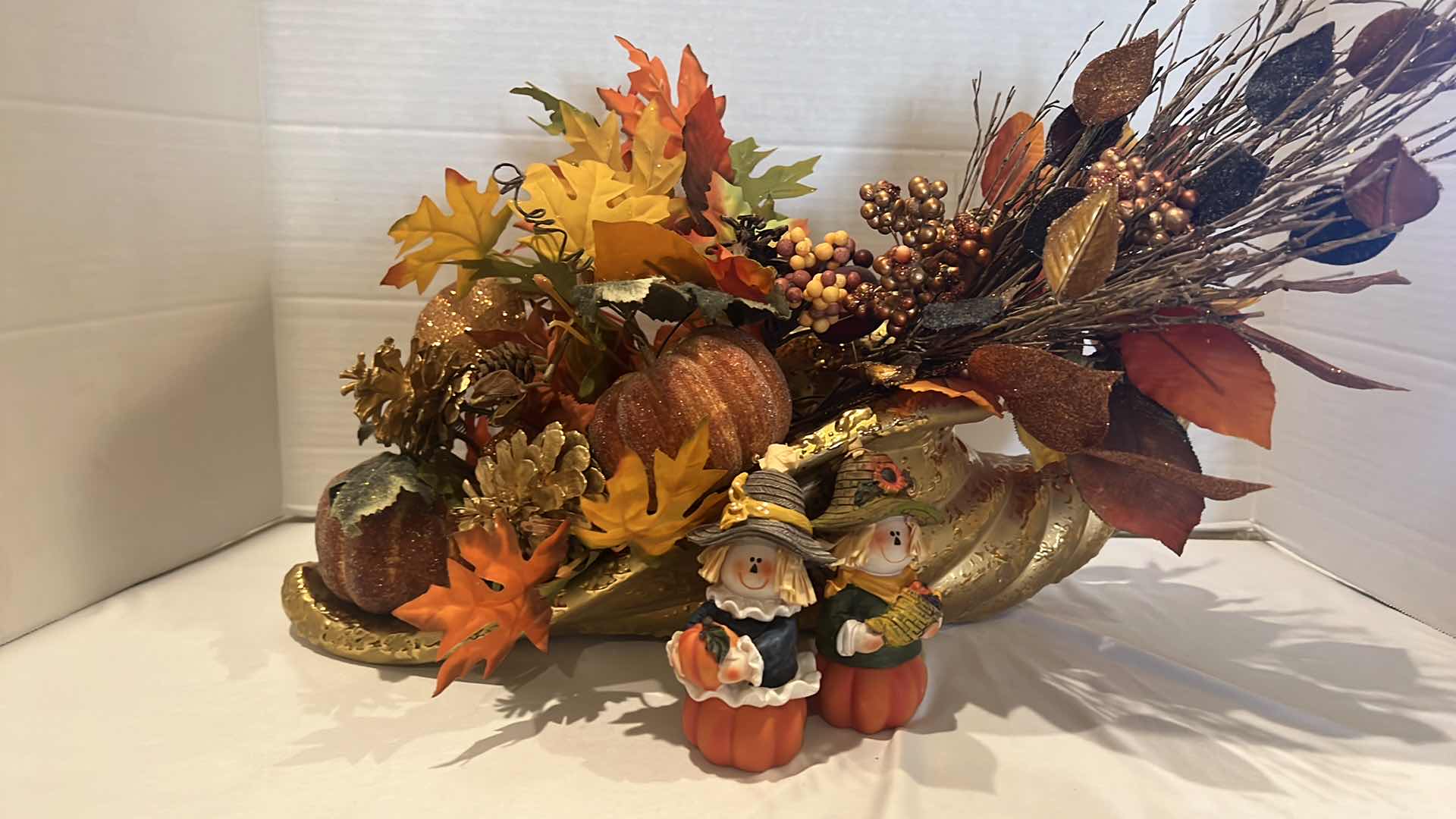 Photo 1 of GOLD METAL CORNUCOPIA FALL FAUX FLORAL ARRANGEMENT W20", 2-WOOD PILGRIM FIGURINES H5"