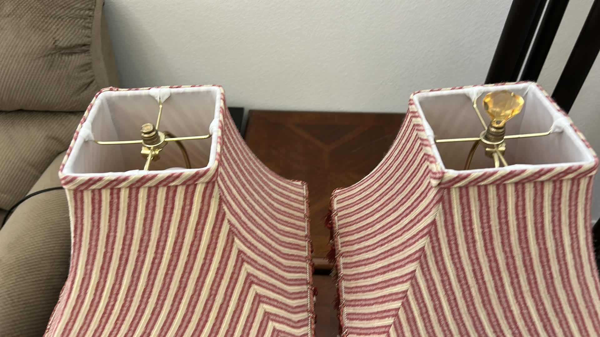 Photo 1 of 2 ANTIQUE GOLD COLORED TABLE LAMPS WITH RED AND IVORY FABRIC SHADES WITH TASSELS H26”