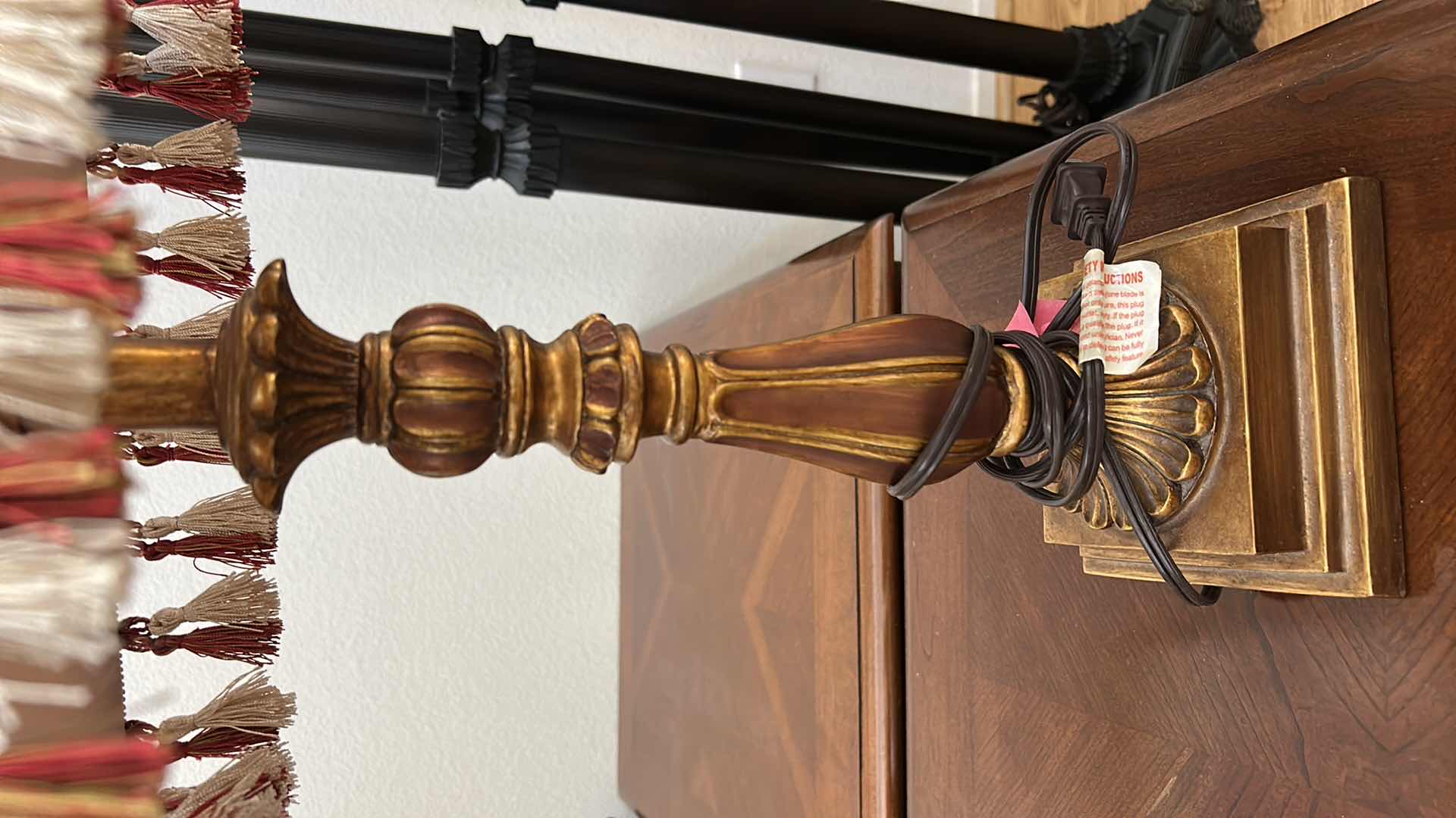 Photo 1 of 2 ANTIQUE GOLD COLORED TABLE LAMPS WITH RED AND IVORY FABRIC SHADES WITH TASSELS H26”
