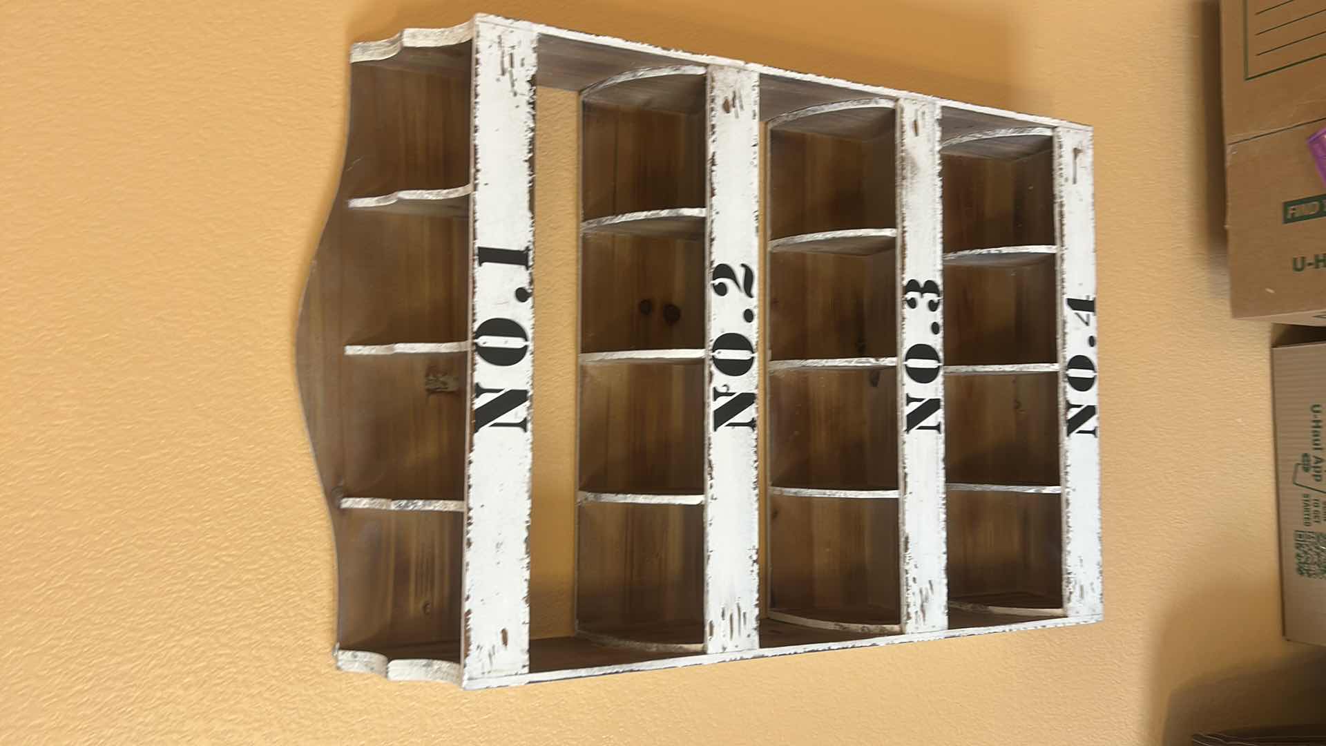 Photo 1 of DISTRESSED WHITE WOODEN WALL ORGANIZER WITH NUMBERED COMPARTMENTS. 22“ x 5“ x H34“.
