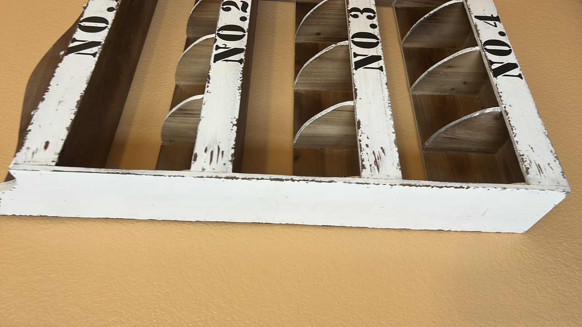 Photo 1 of DISTRESSED WHITE WOODEN WALL ORGANIZER WITH NUMBERED COMPARTMENTS. 22“ x 5“ x H34“.