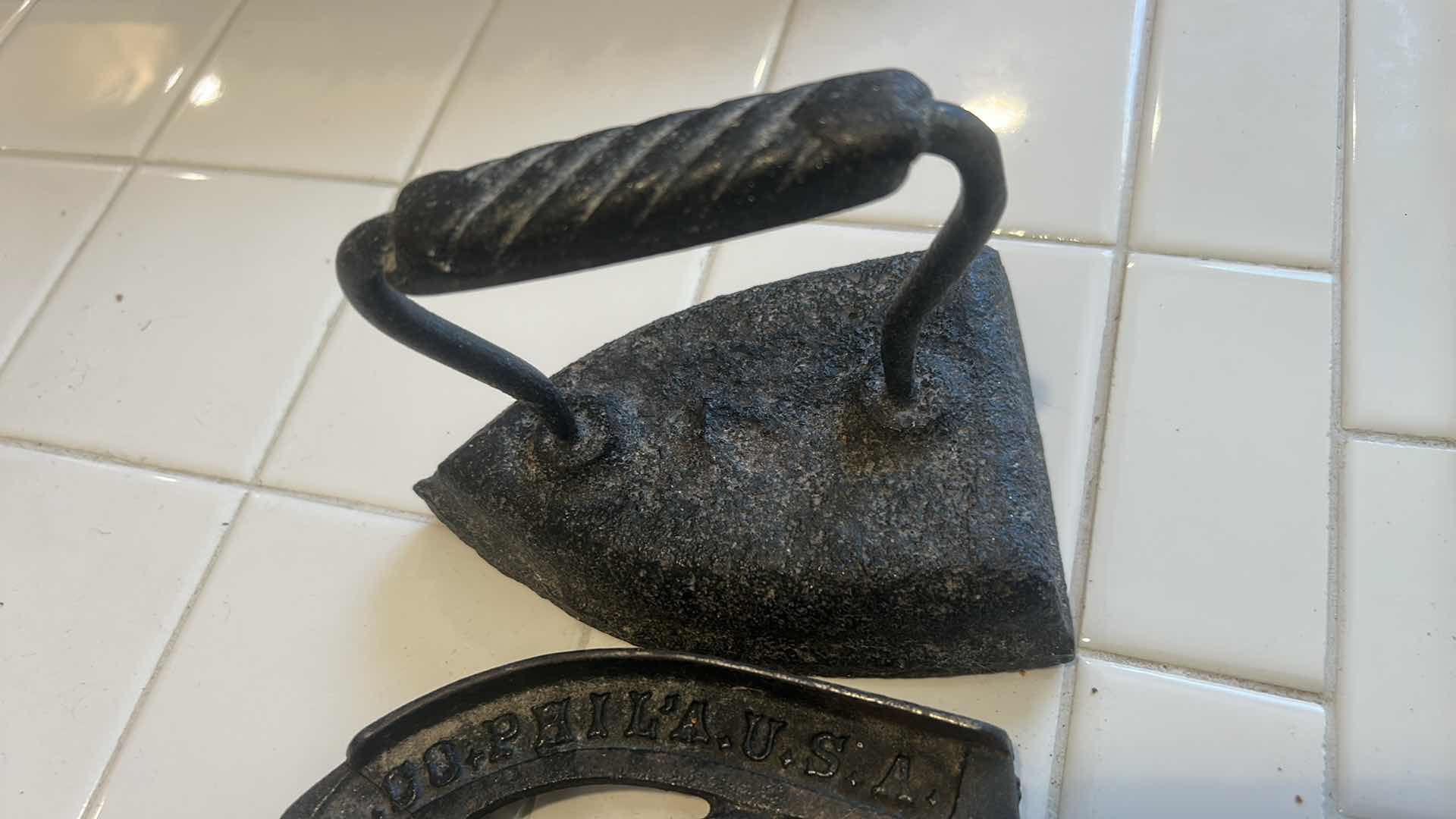 Photo 1 of ANTIQUE SAD IRON AND MATCHING TRIVET