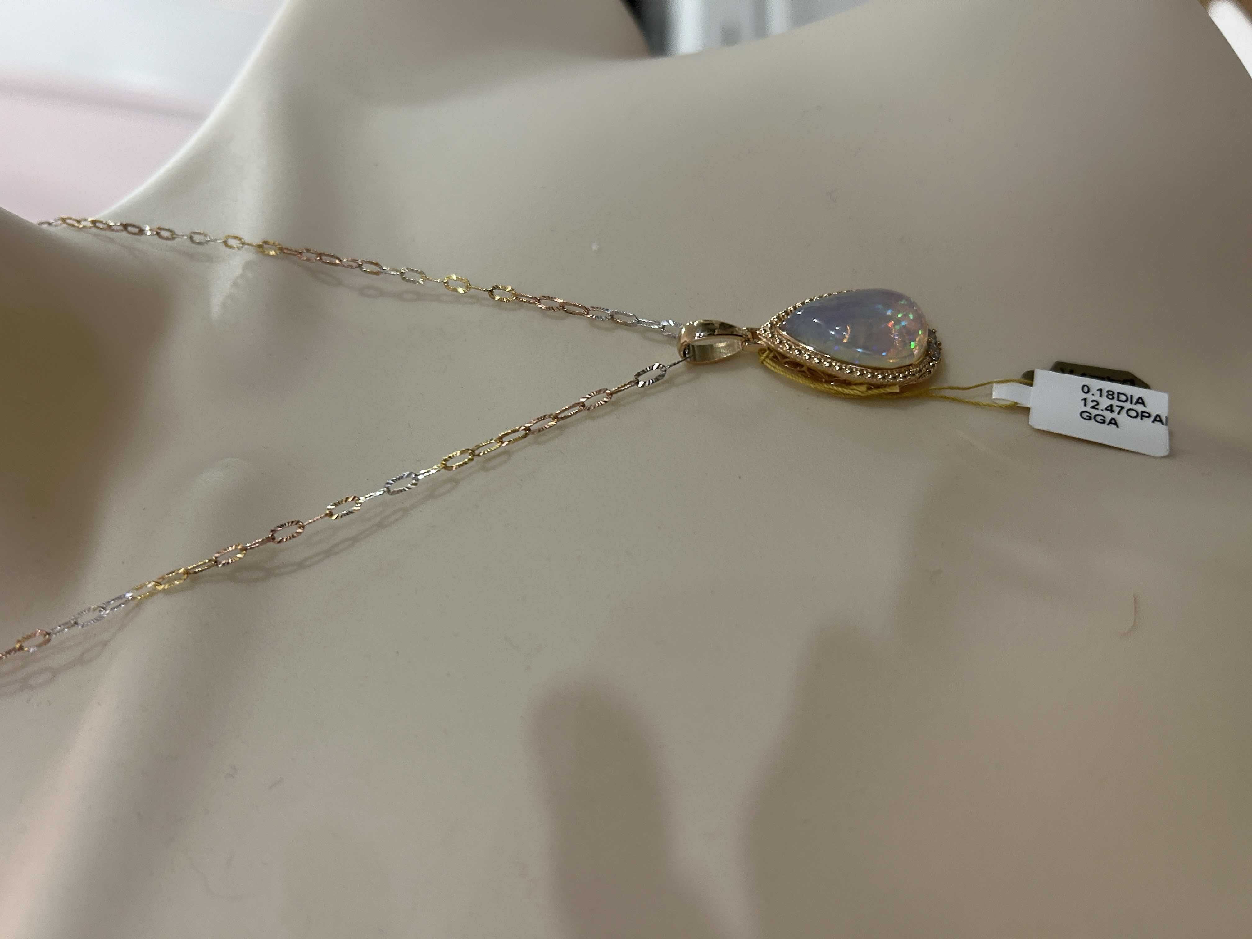 Photo 1 of STERLING SILVER W 18K GOLD OVERLAY W NATURAL OPAL (PLAY OF COLOR) APPROX 12.47 CTW PEAR CABOCHON PENDANT AND NATURAL DIAMOND 0.18 CTW GGA CERTIFIED -NK017295