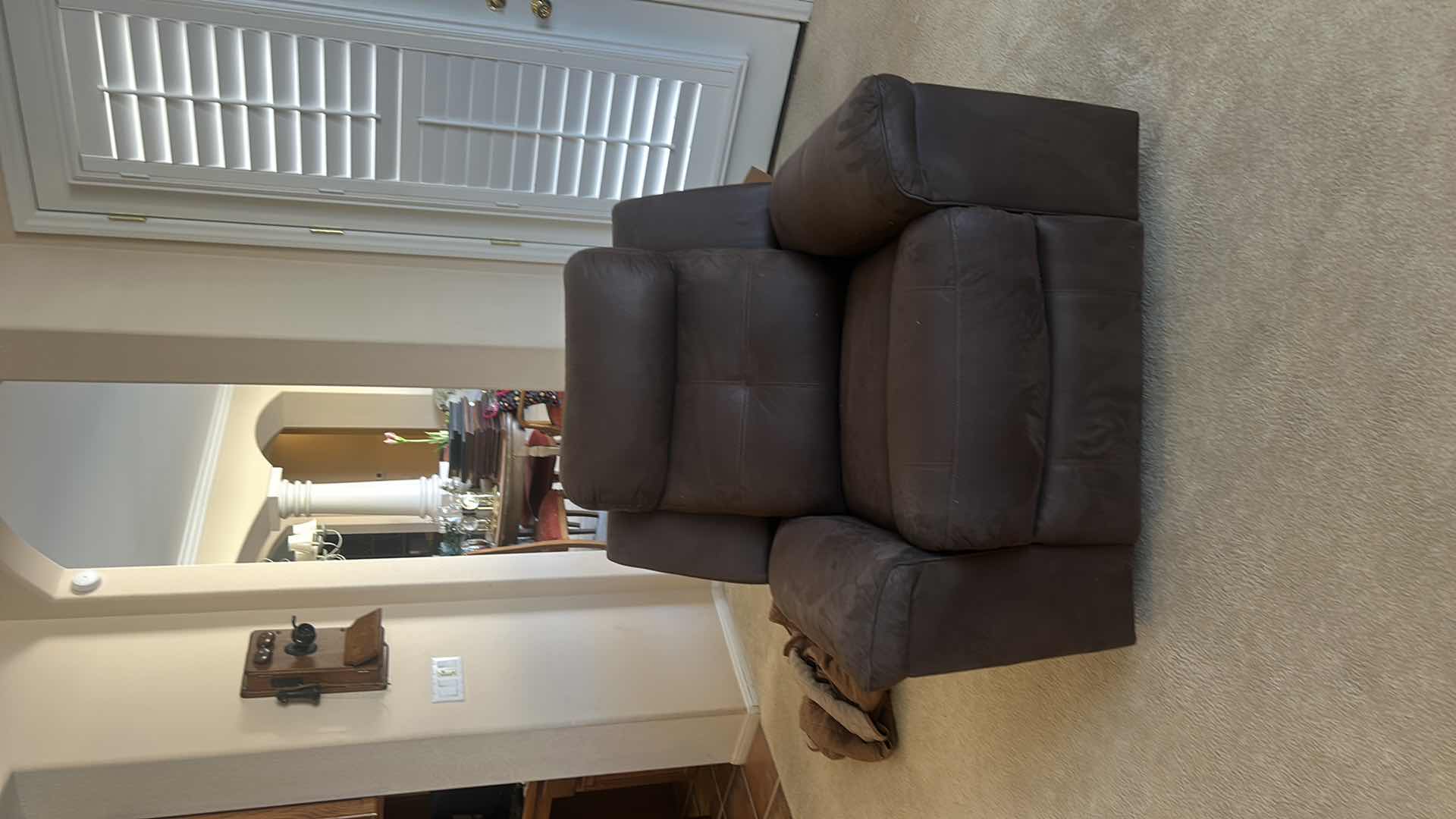 Photo 1 of ASHLEY FURNITURE ROCKER RECLINER WITH LEATHER-LOOK UPHOLSTERY. MADE OF POLYURETHANE, POLYESTER, AND FIBER MATERIALS.