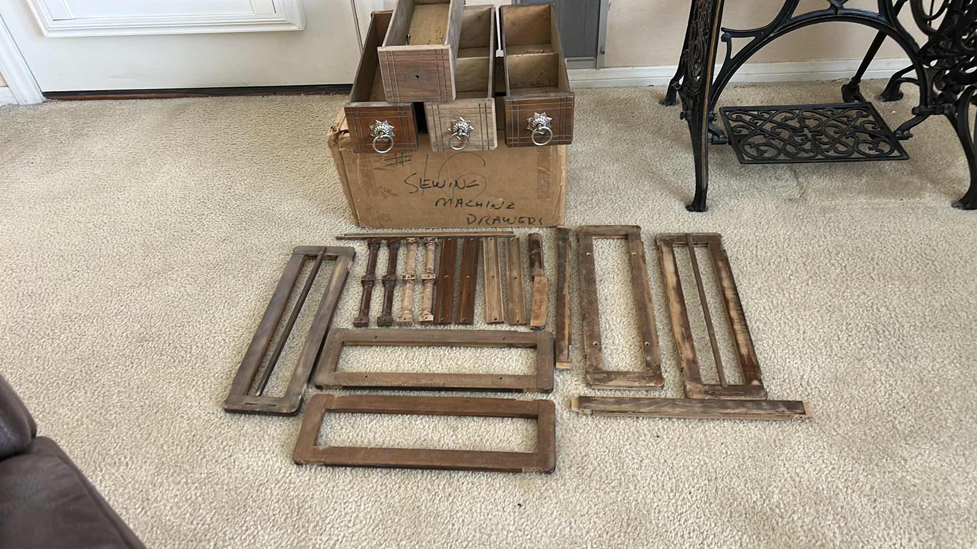 Photo 1 of ANTIQUE HELVETIA TREADLE SEWING MACHINE AND CABINET, ORNATE CAST IRON AND GOLD DETAILING PLUS PARTS. INCLUDES CAST IRON TREADLE BASE, SEWING MACHINE HEAD, WOOD TABLE TOP, DRAWERS, AND LOOSE WOOD COMPONENTS.
36 1/2“ x 18 1/2“ x H32“