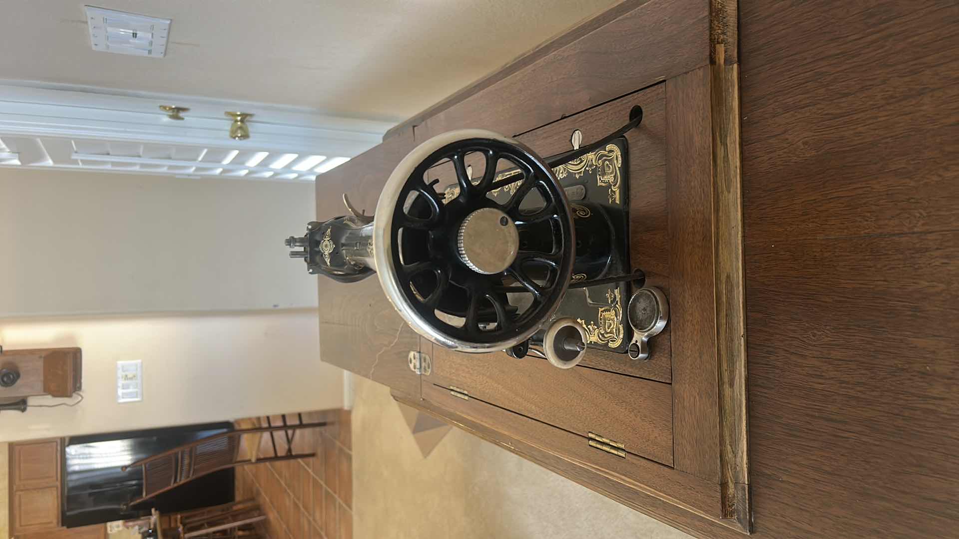 Photo 1 of ANTIQUE HELVETIA TREADLE SEWING MACHINE AND CABINET, ORNATE CAST IRON AND GOLD DETAILING PLUS PARTS. INCLUDES CAST IRON TREADLE BASE, SEWING MACHINE HEAD, WOOD TABLE TOP, DRAWERS, AND LOOSE WOOD COMPONENTS.
36 1/2“ x 18 1/2“ x H32“