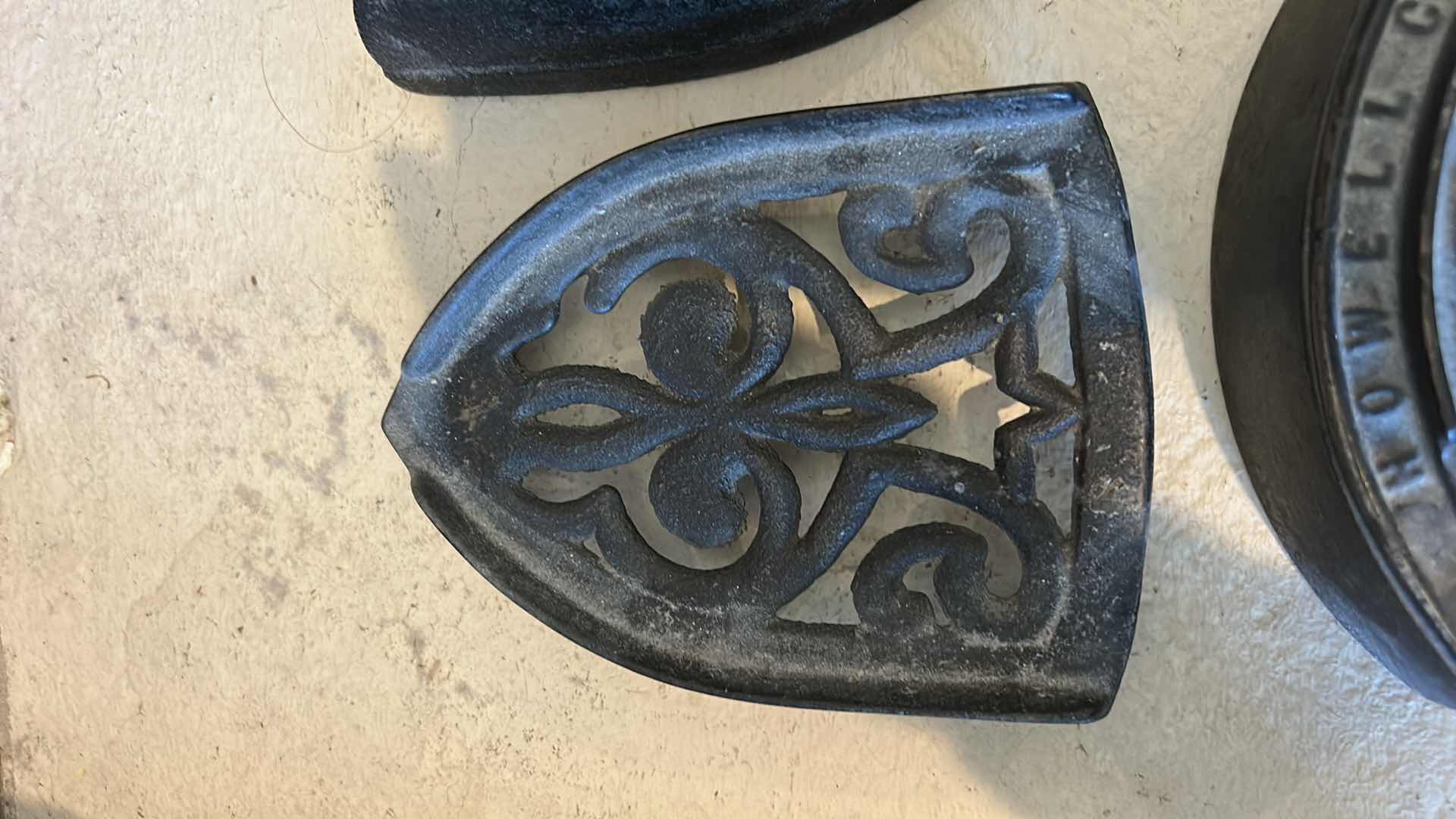 Photo 1 of ANTIQUE CAST IRON IRONS AND IRON TRIVETS. INCLUDES SAD IRONS AND DECORATIVE IRON RESTS